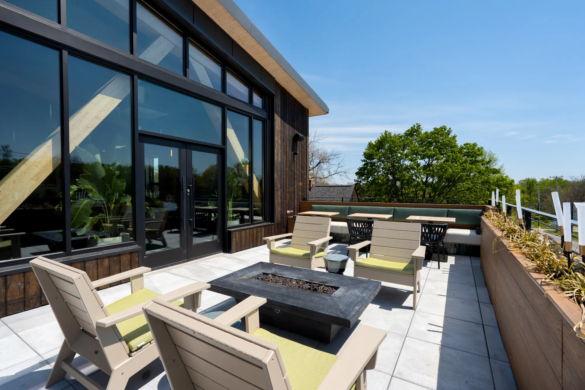 Terrace with fire pit and lounge chairs at Lani Rooftop