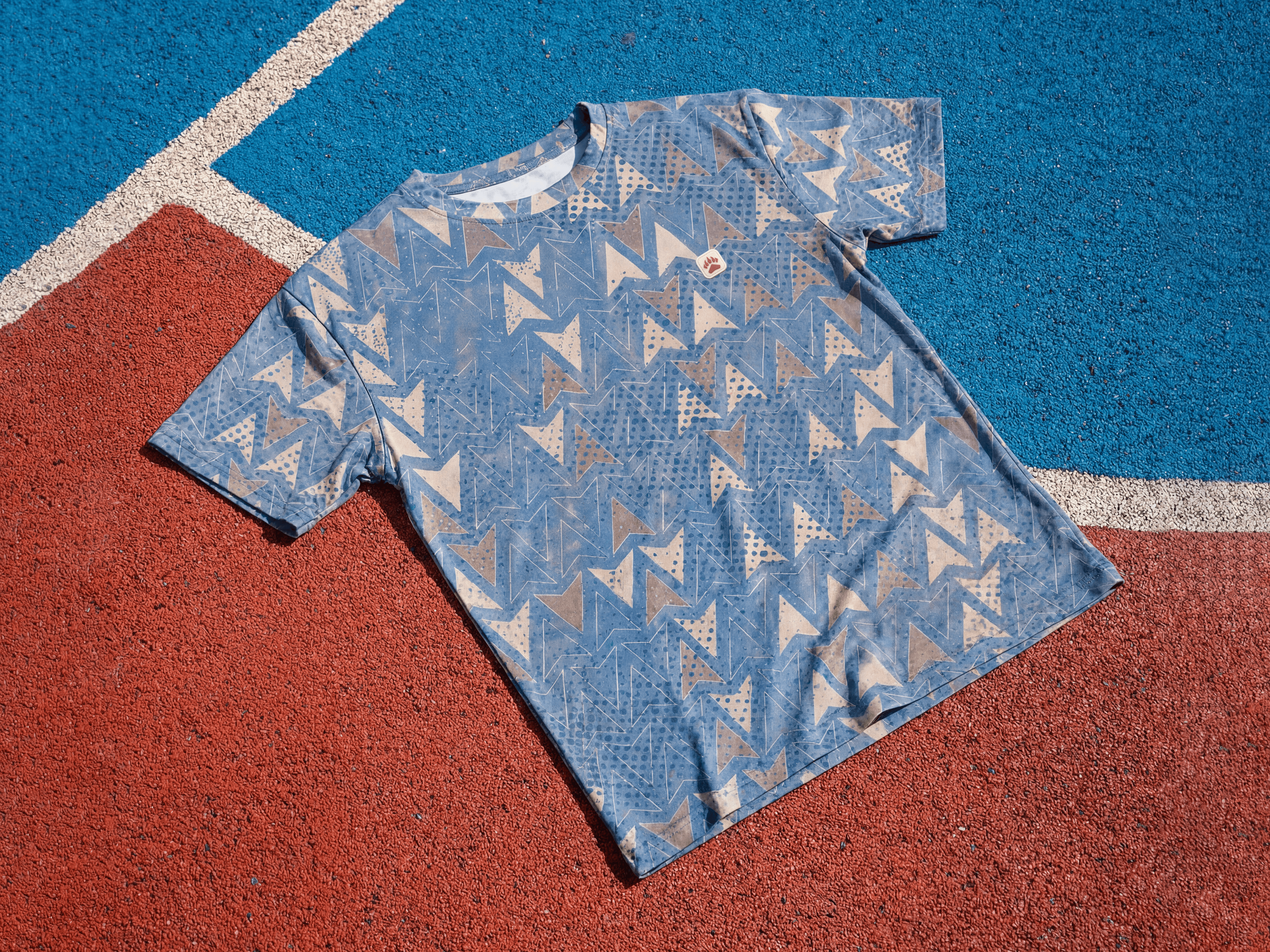 Mannequin in store window wearing orange shirt and jacket