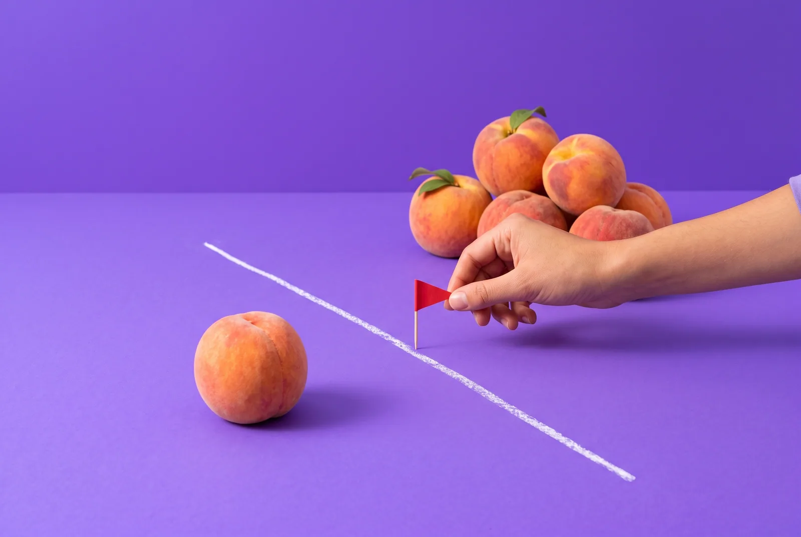 A hand planting a red flag on a chalk line between one peach and a pile, lapse vs relapse and the chaser effect