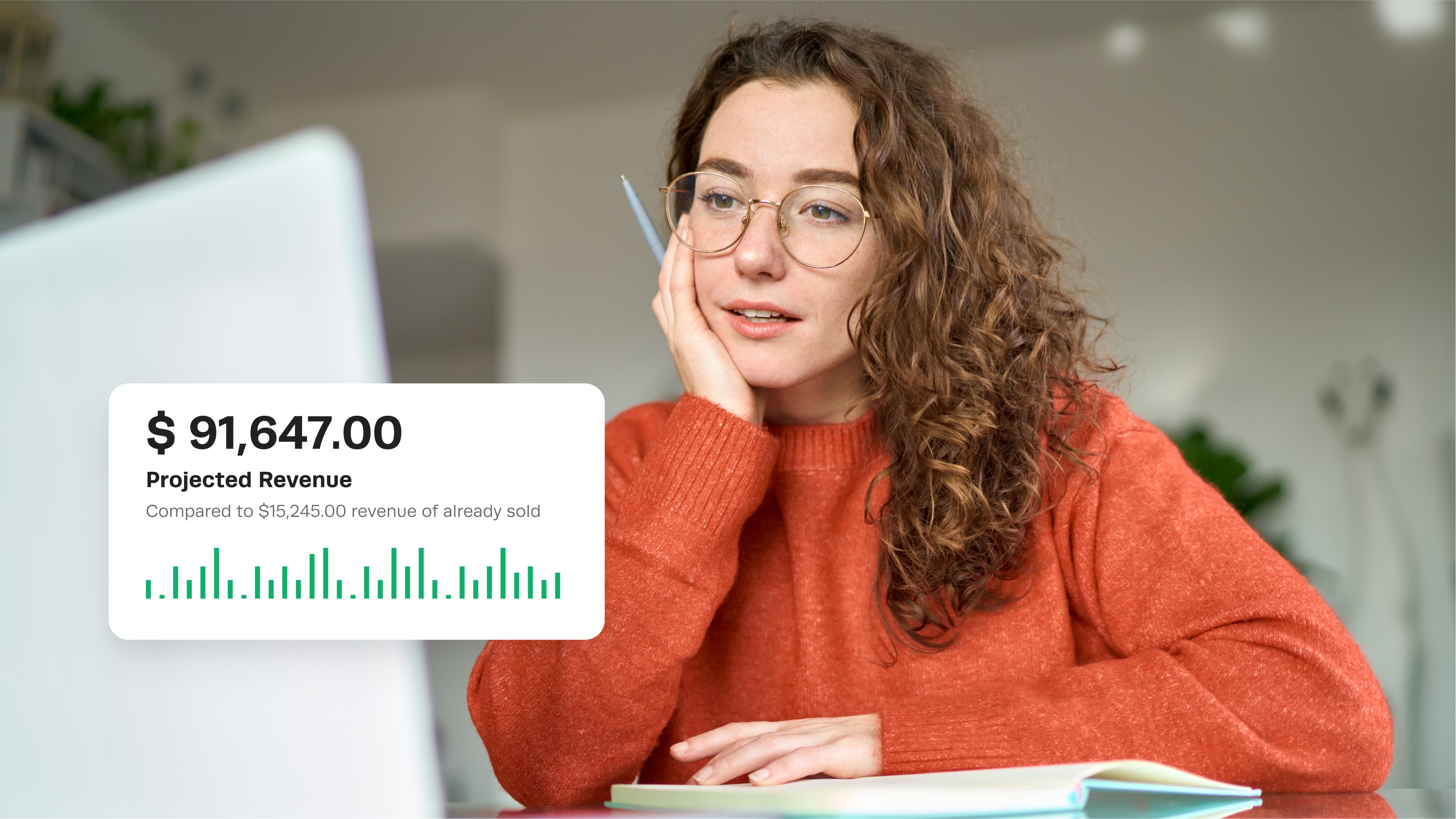 Woman viewing projected revenue on laptop