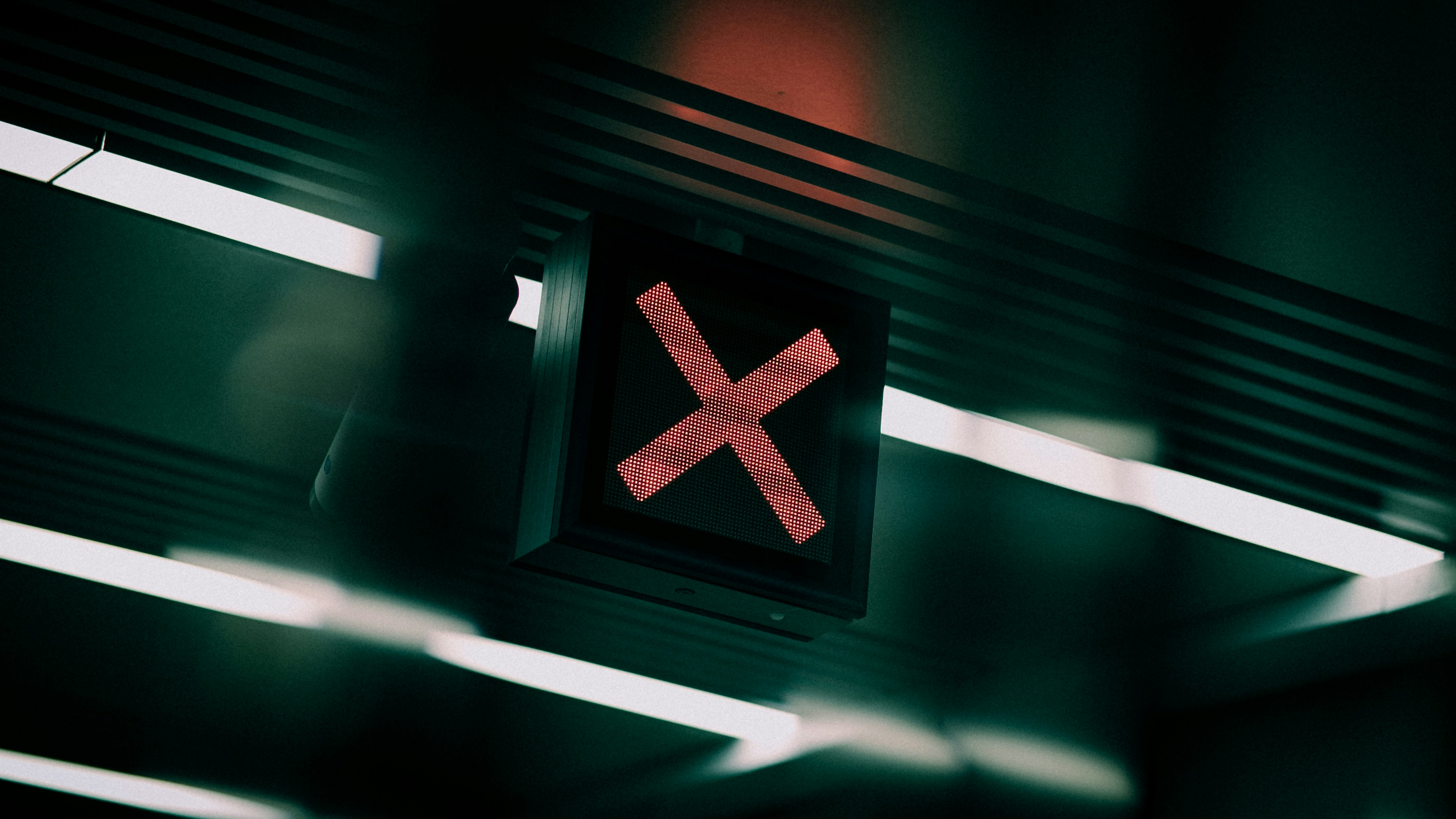 a close up of a traffic light with a red x on it