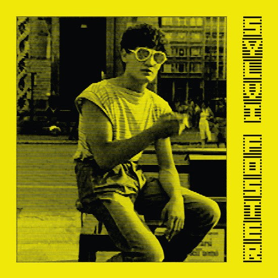 Person sitting on a bench with a yellow border and text on a black and white photo.