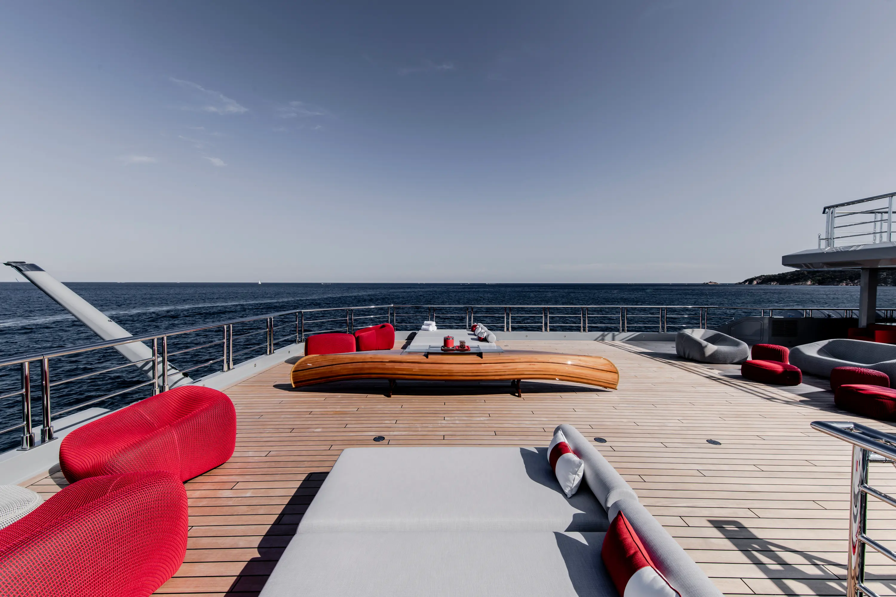 Sunlit lounge with orange chairs by glass window.