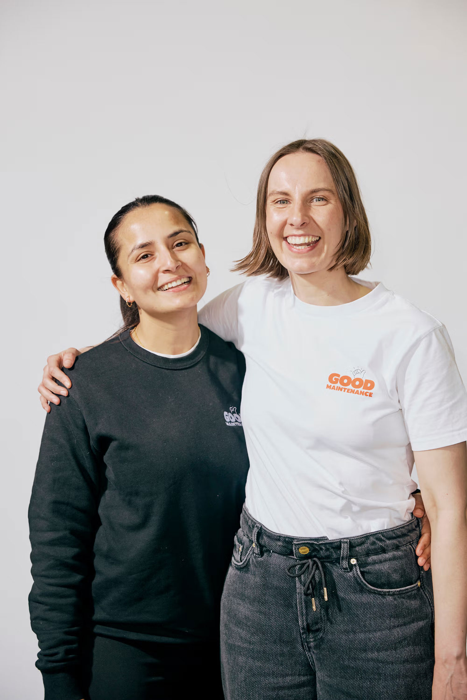Two female Team Members in Good Maintenance Shirts, smiling.