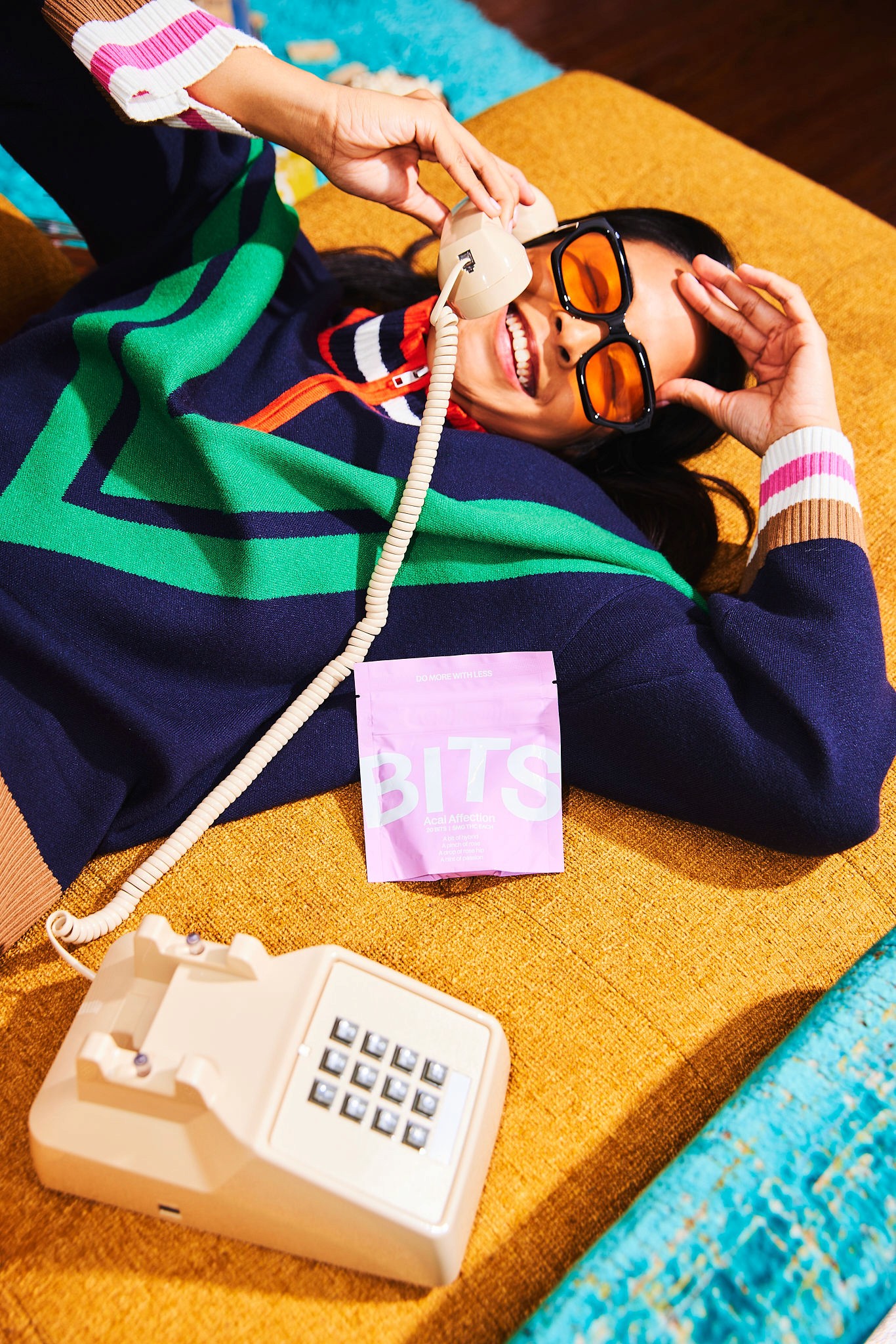 A tan sighthound stands in a grassy field.