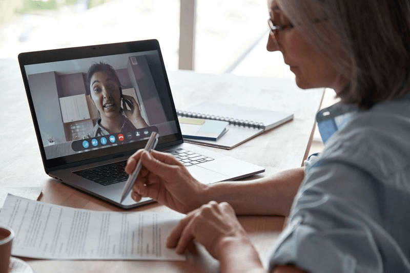 A doctor conducts a call in a laptop computer