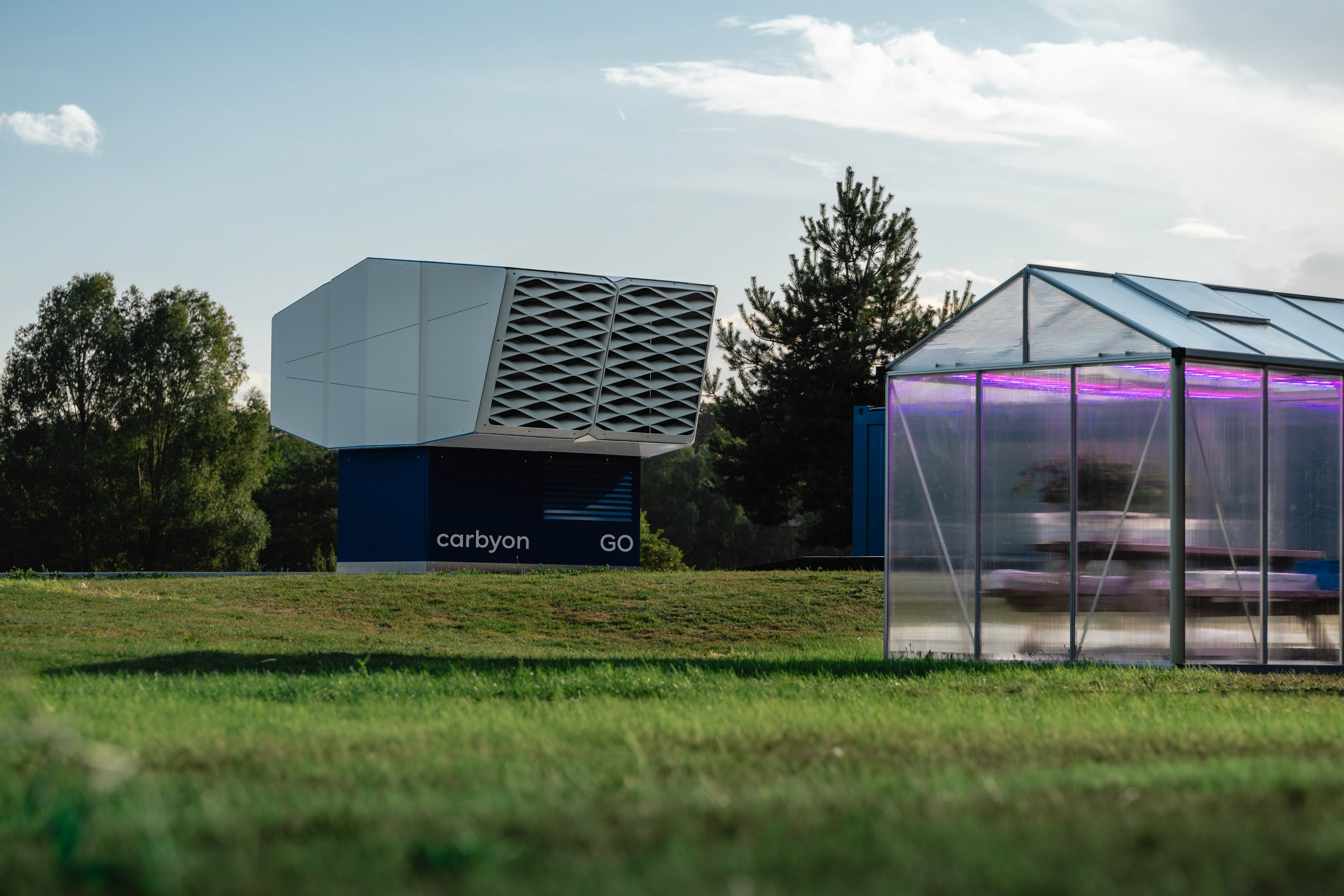 Lightyear 0 electric car showcased at its unveiling event in Spain, against a bright blue sky with scattered clouds, highlighting its futuristic design and aerodynamic lines.