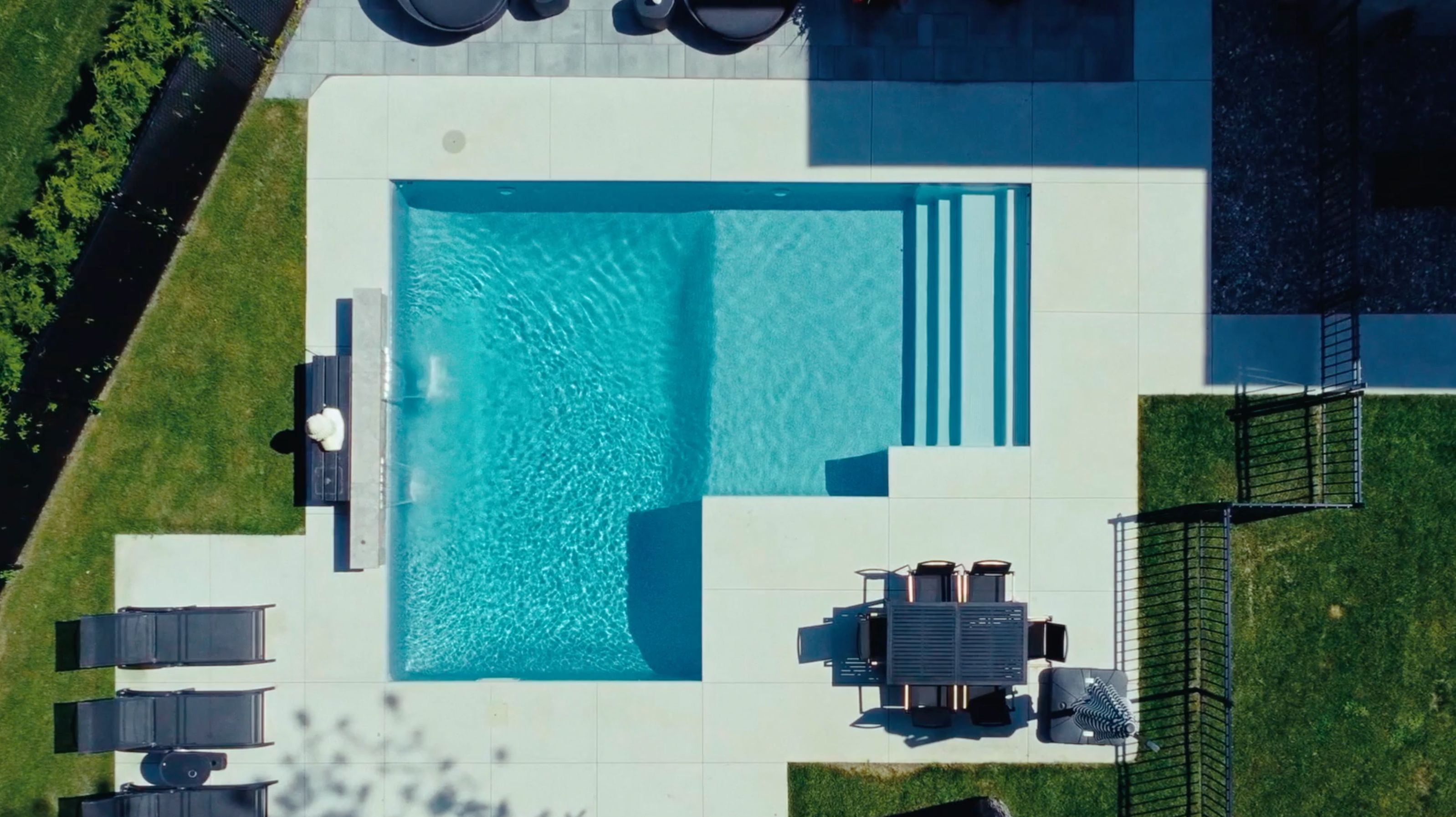 Aerial view of an in-ground pool in the yard of a house