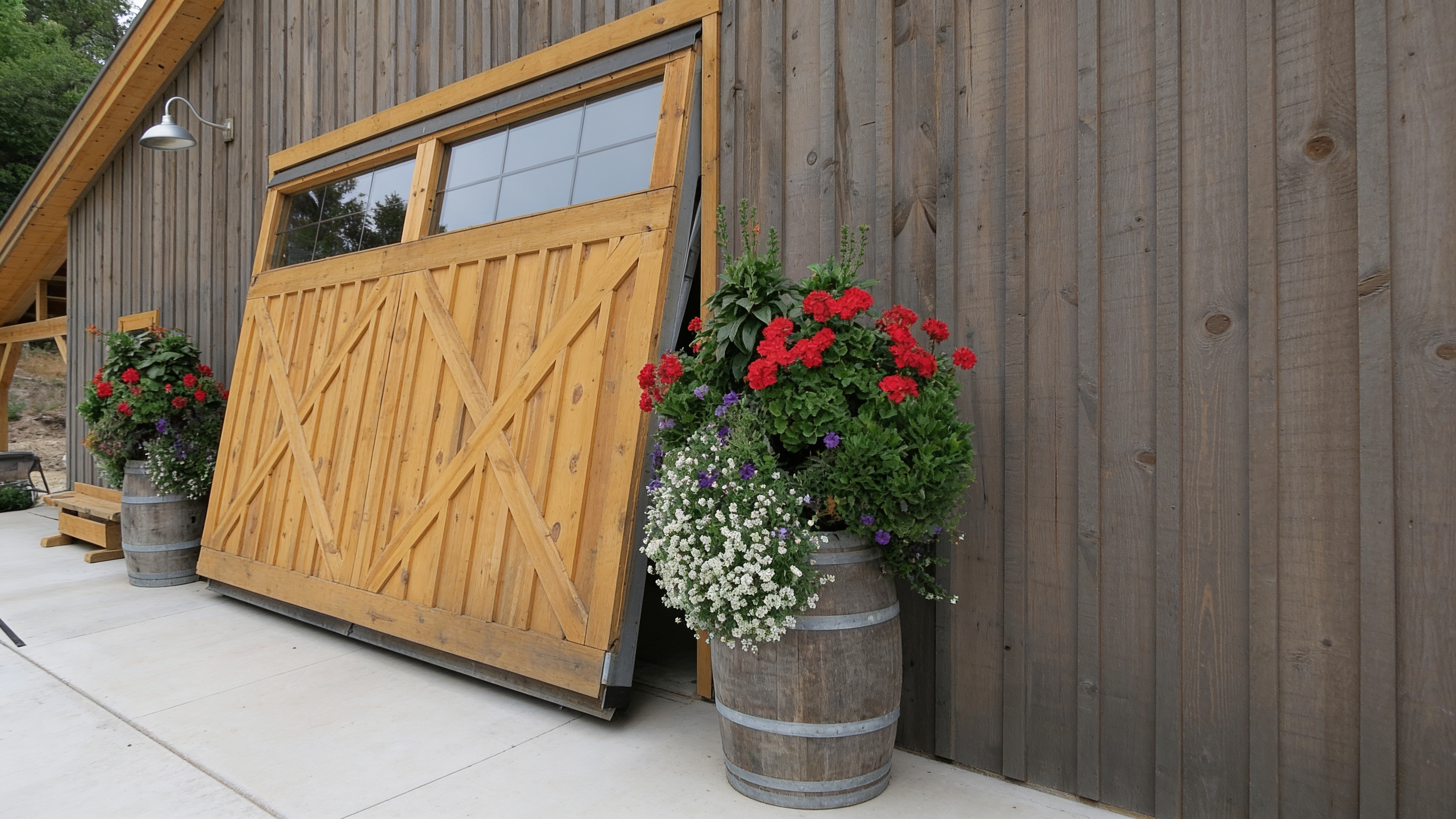 20-foot wood-clad concealed cylinder door with glass panes on a guest barn