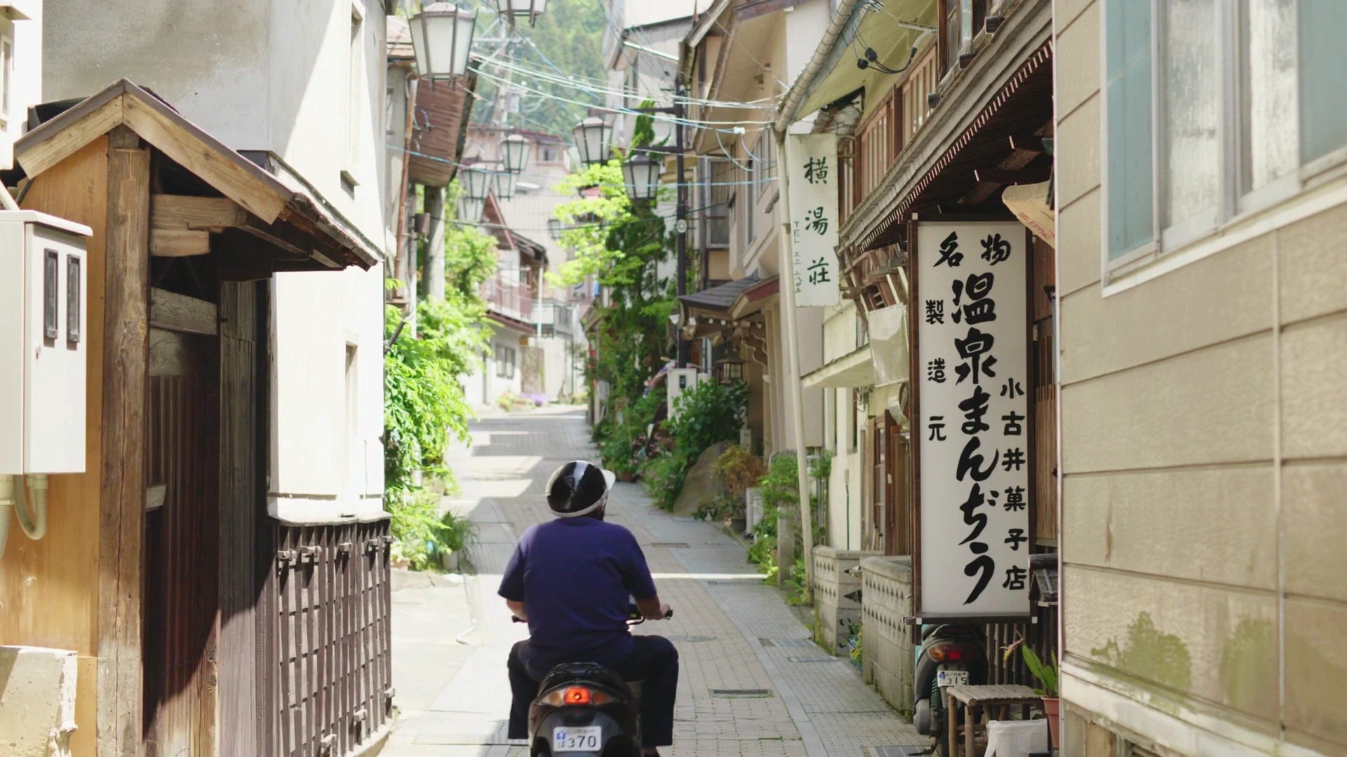 Narrow stone lane through Shibu Onsen between wooden buildings