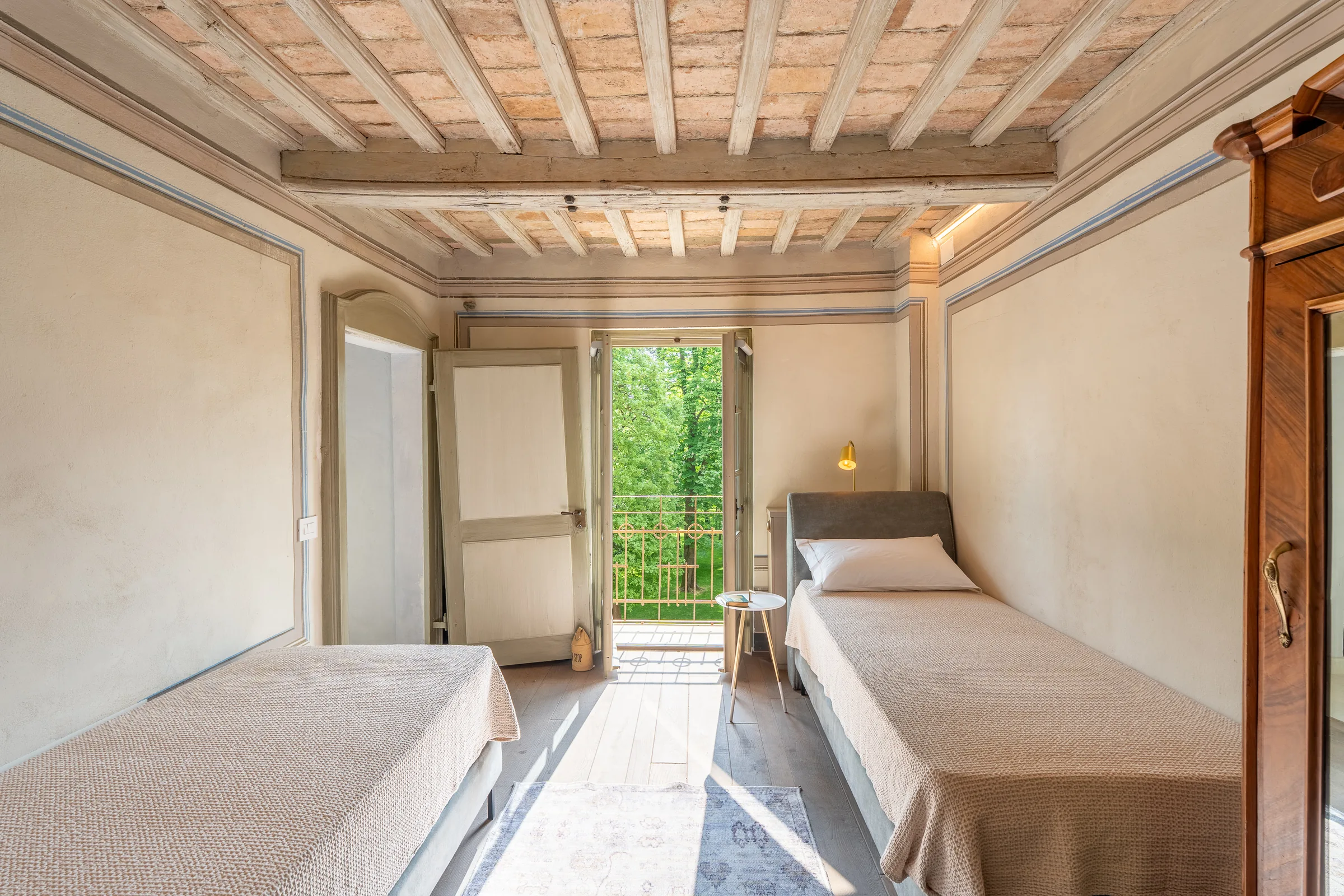 Twin bedroom beneath a coffered ceiling — Nizza Monferrato, Italy. Photography by Yunes Calore.