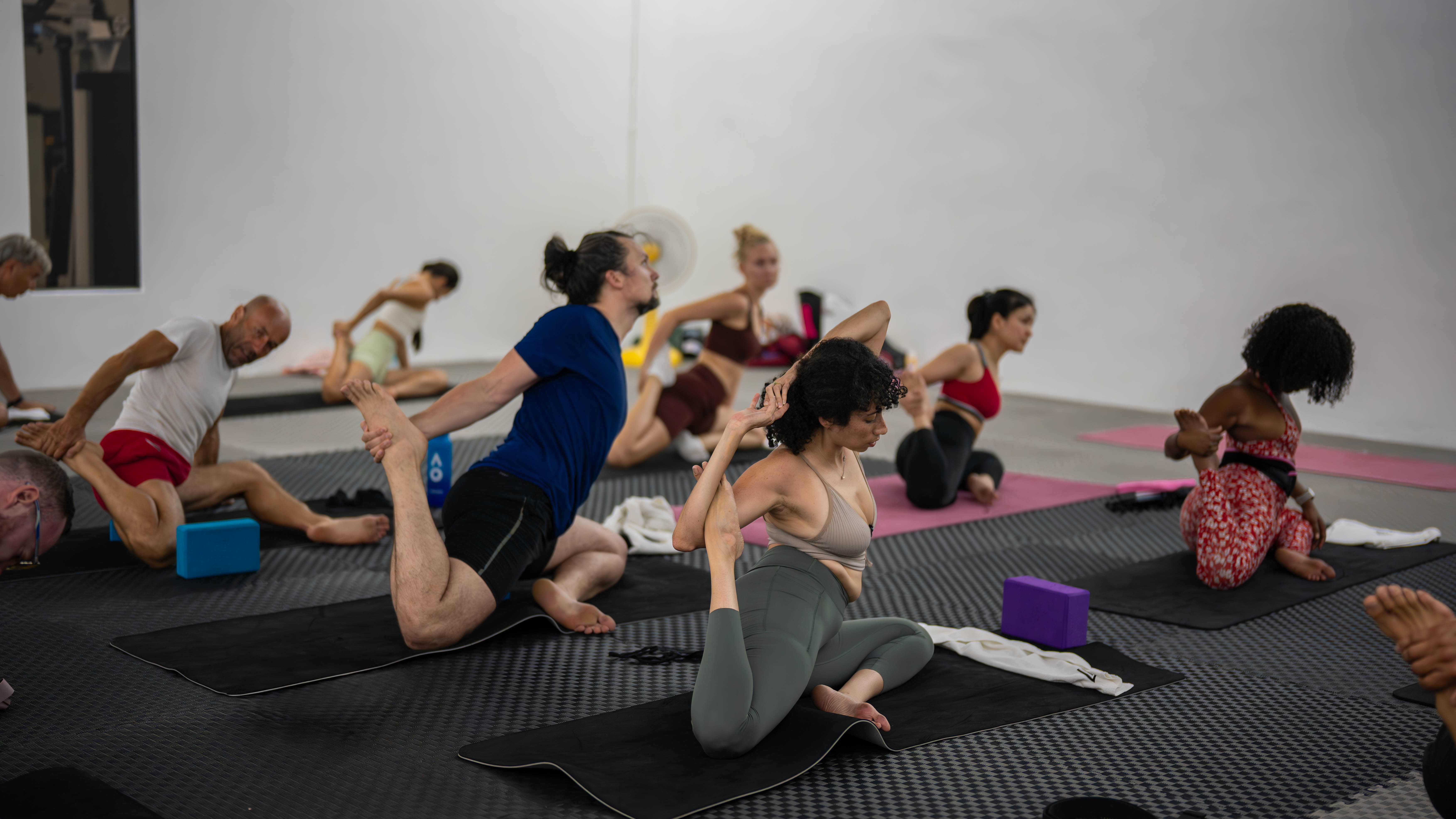 Calming Yoga class at Legacy Muscle Universe Koh Samui, held in the serene Blue Neo Studio for mindfulness and flexibility.
