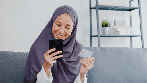 happy women using mobile and card