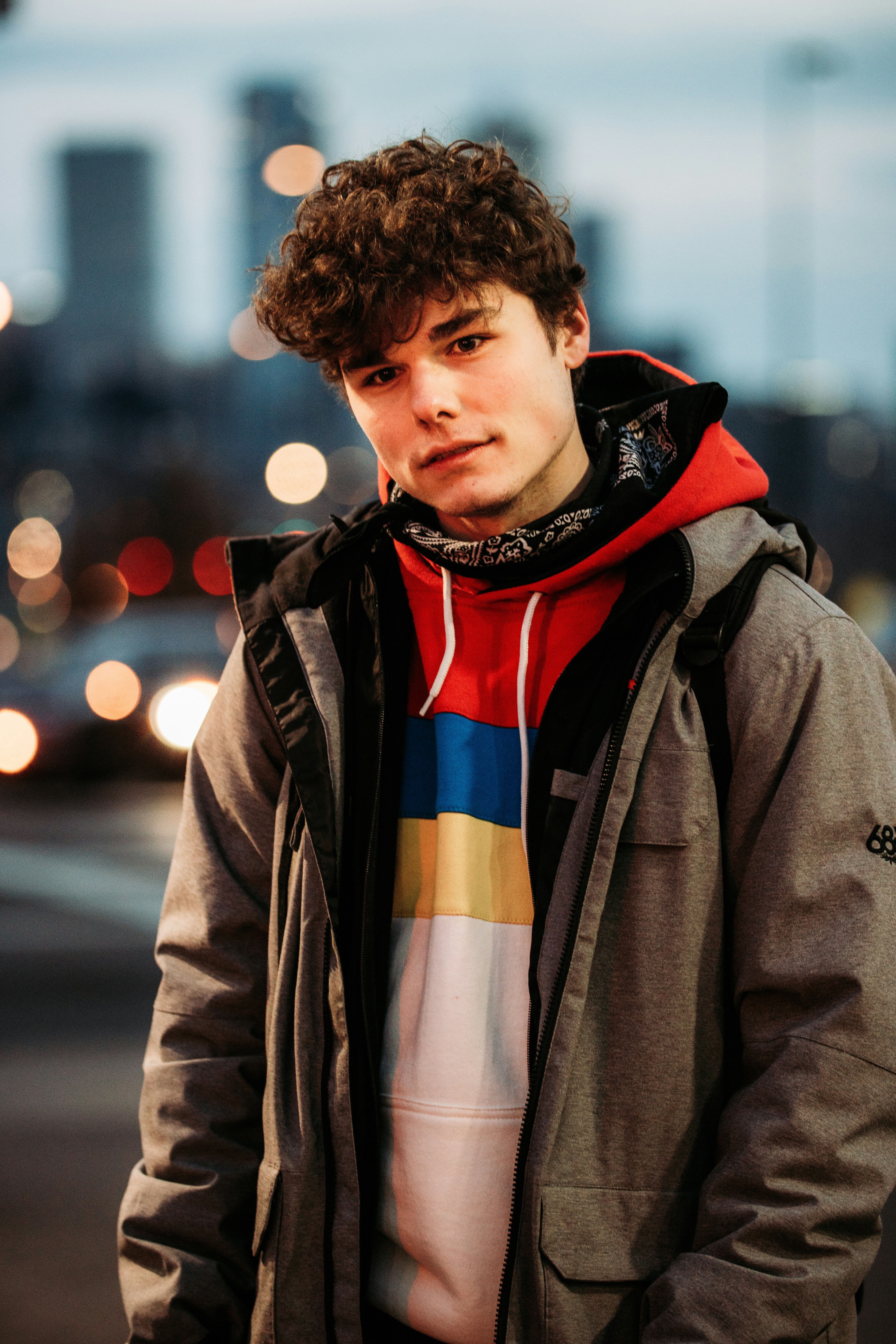 man in brown coat standing during daytime