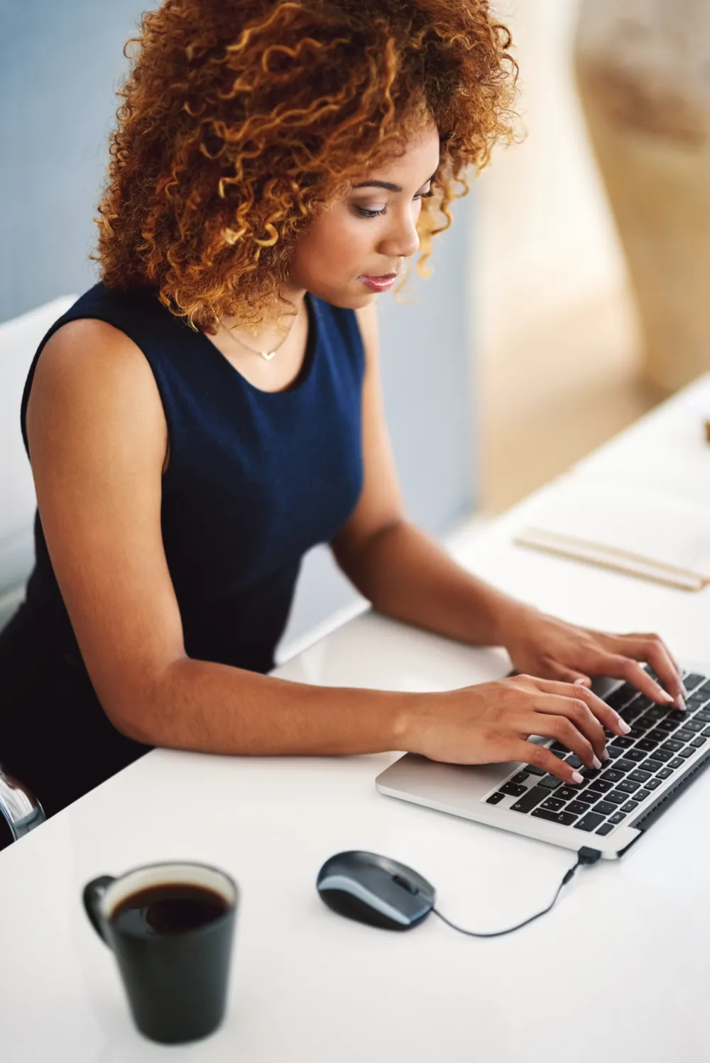 Woman typing on laptop