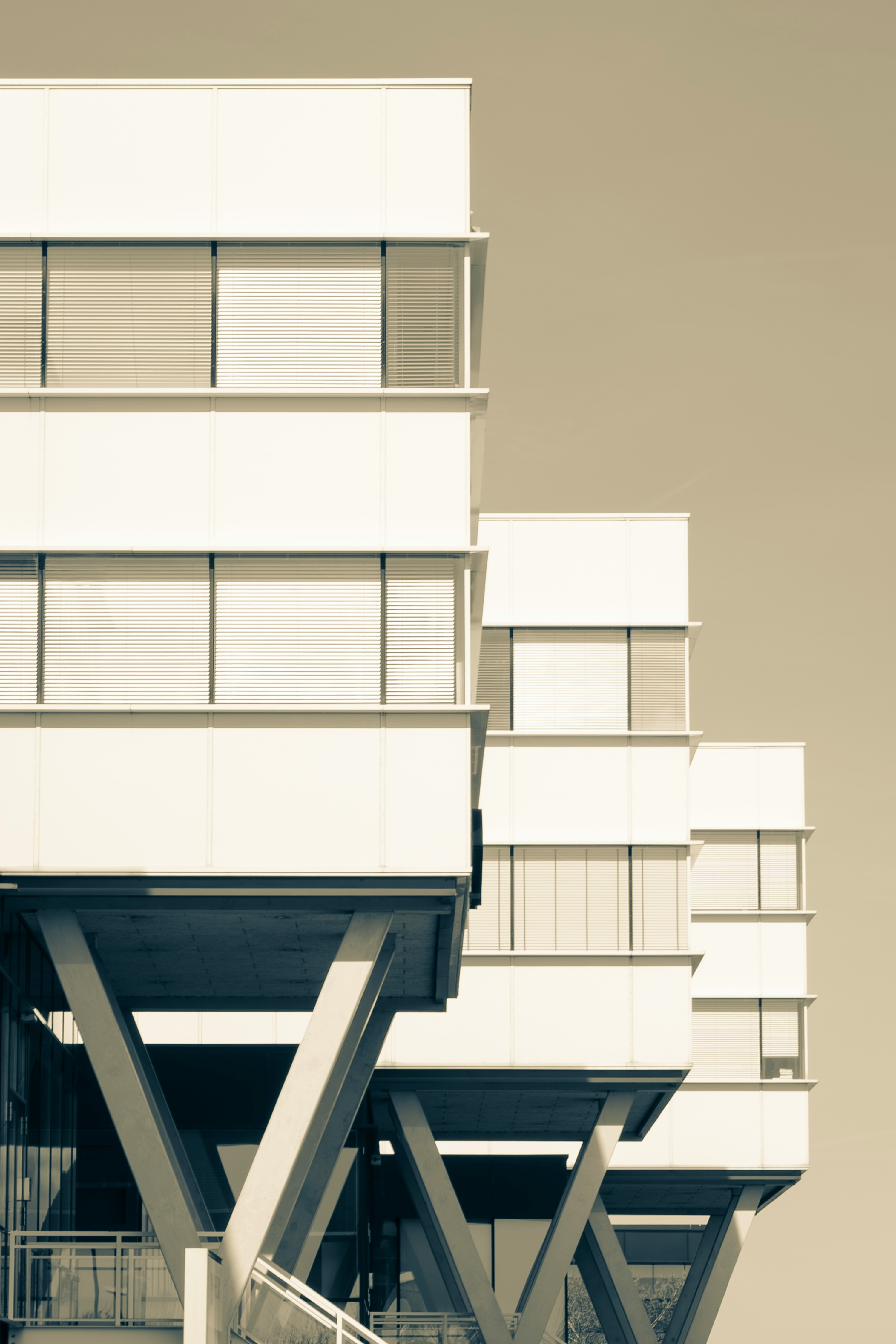 Modern white buildings with angled supports against sky