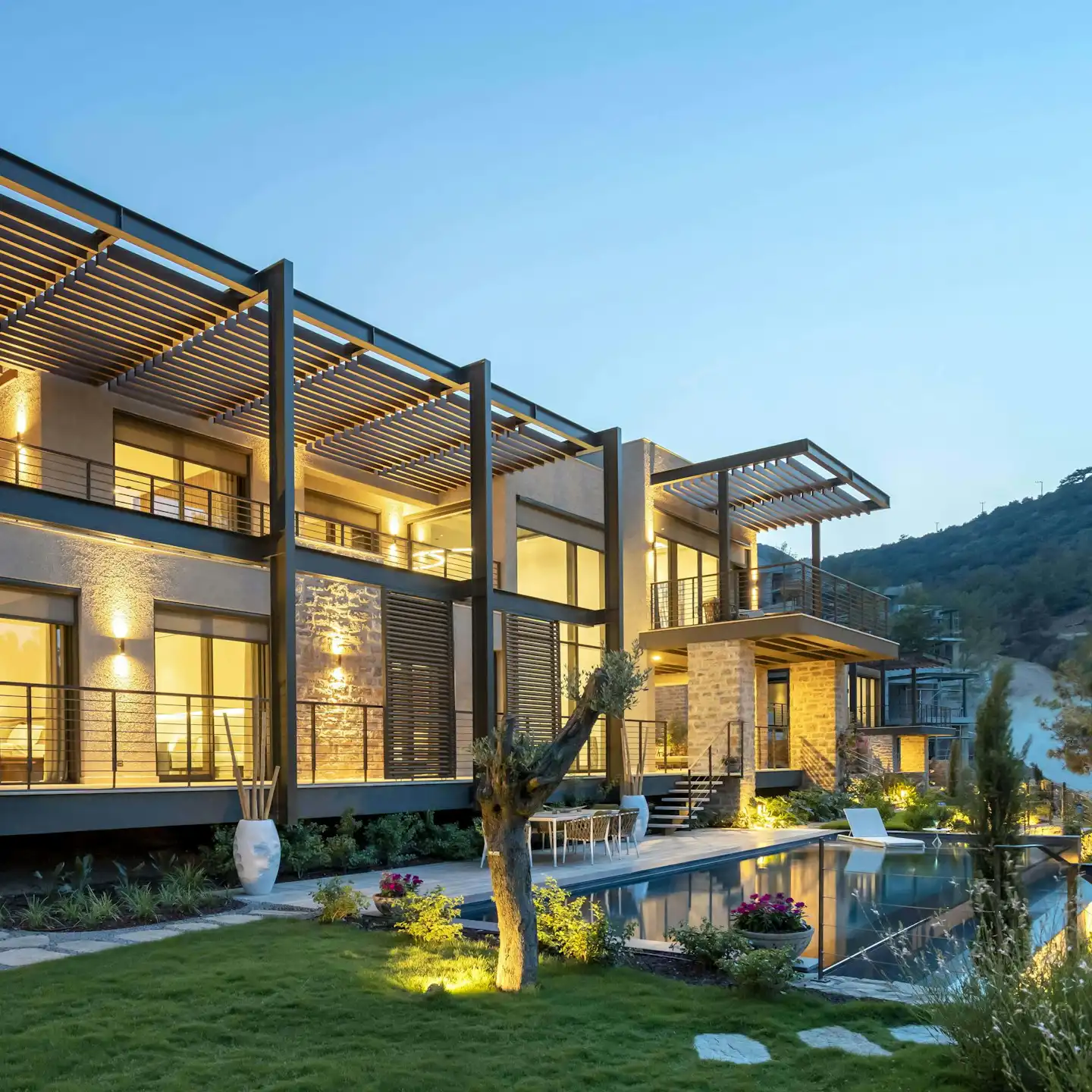 Contemporary home with greenery, lawn, and outdoor pathway