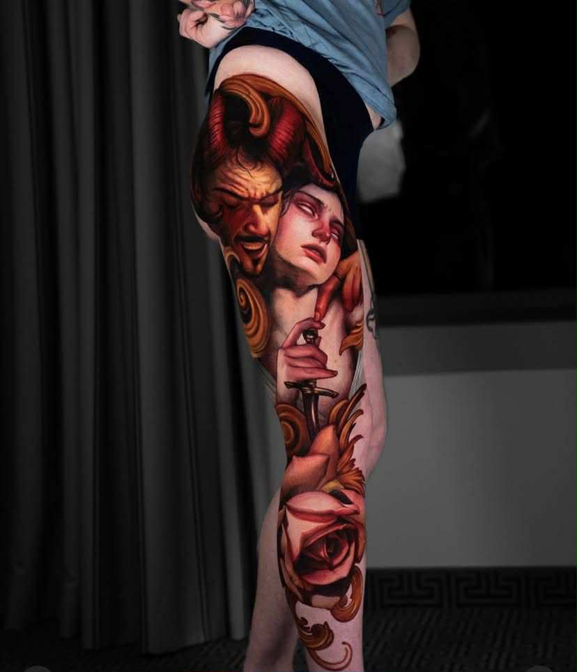 Realistic arm tattoo of broken mask, heart, and red accents.