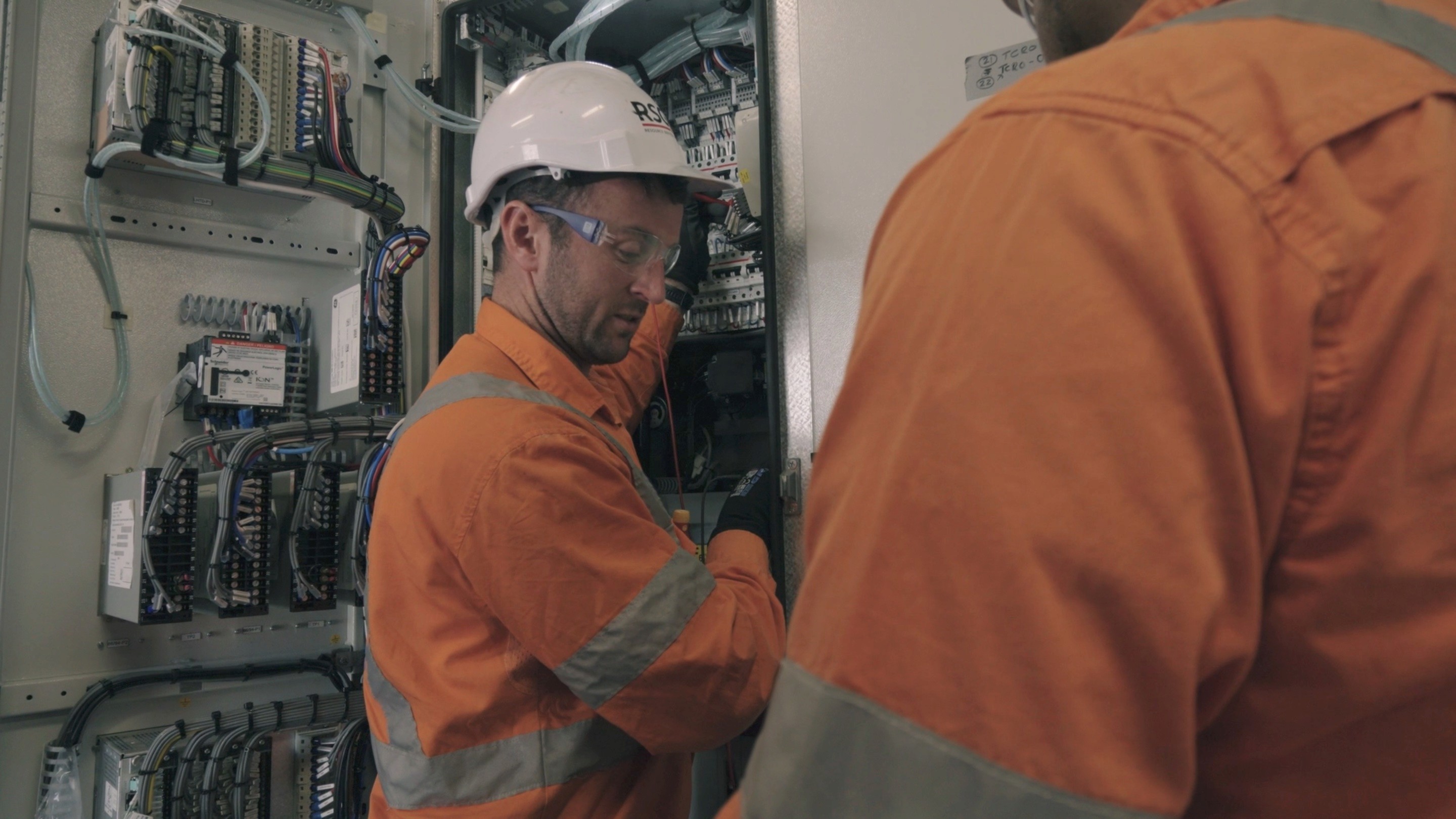 man in safety gear at electrical switch
