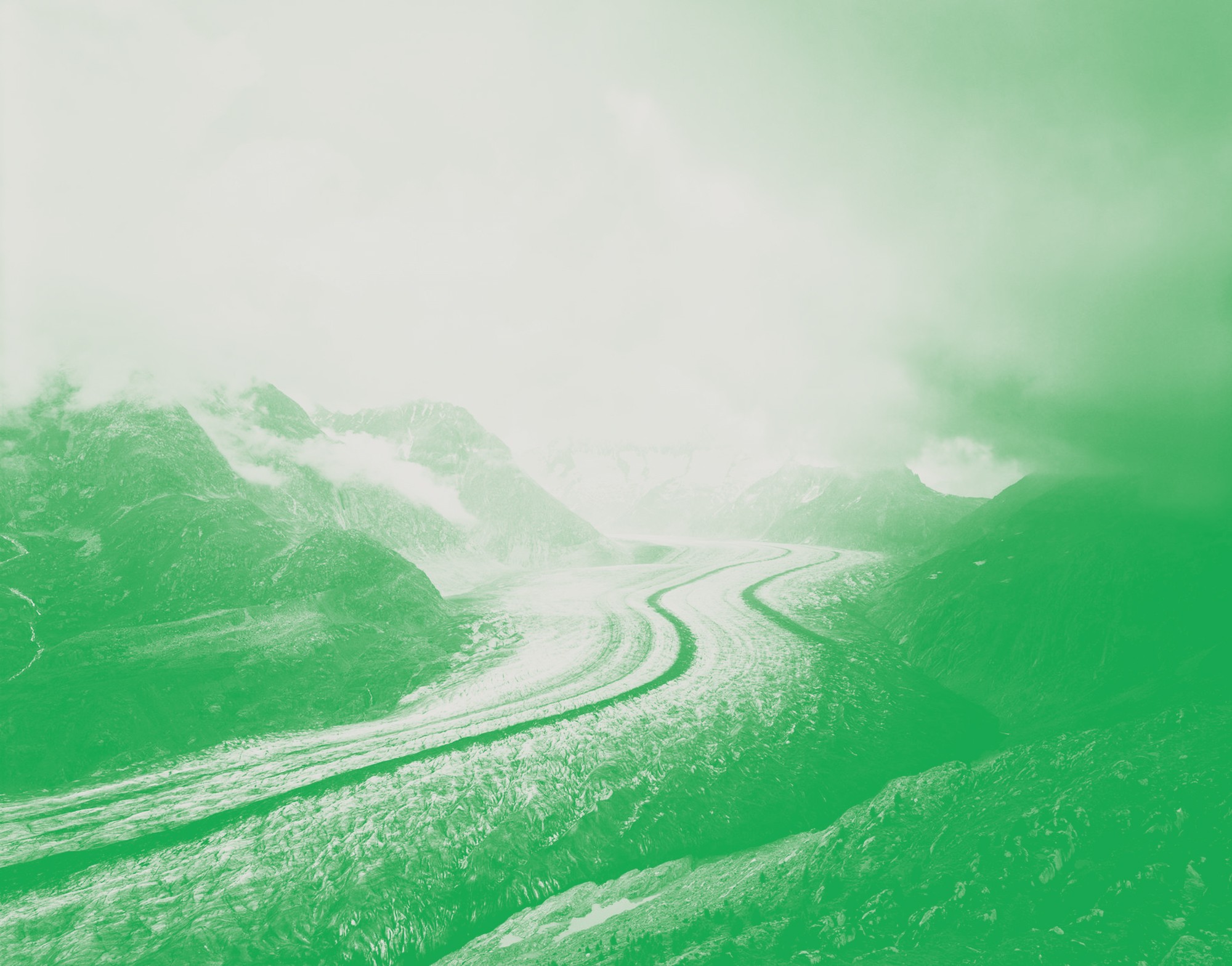 faded green mountainous landscape stretching into the distance glacier