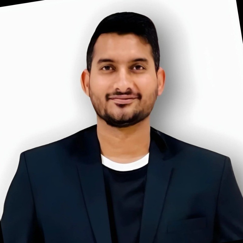 A person in a white shirt black coat with the fair skin looking infront