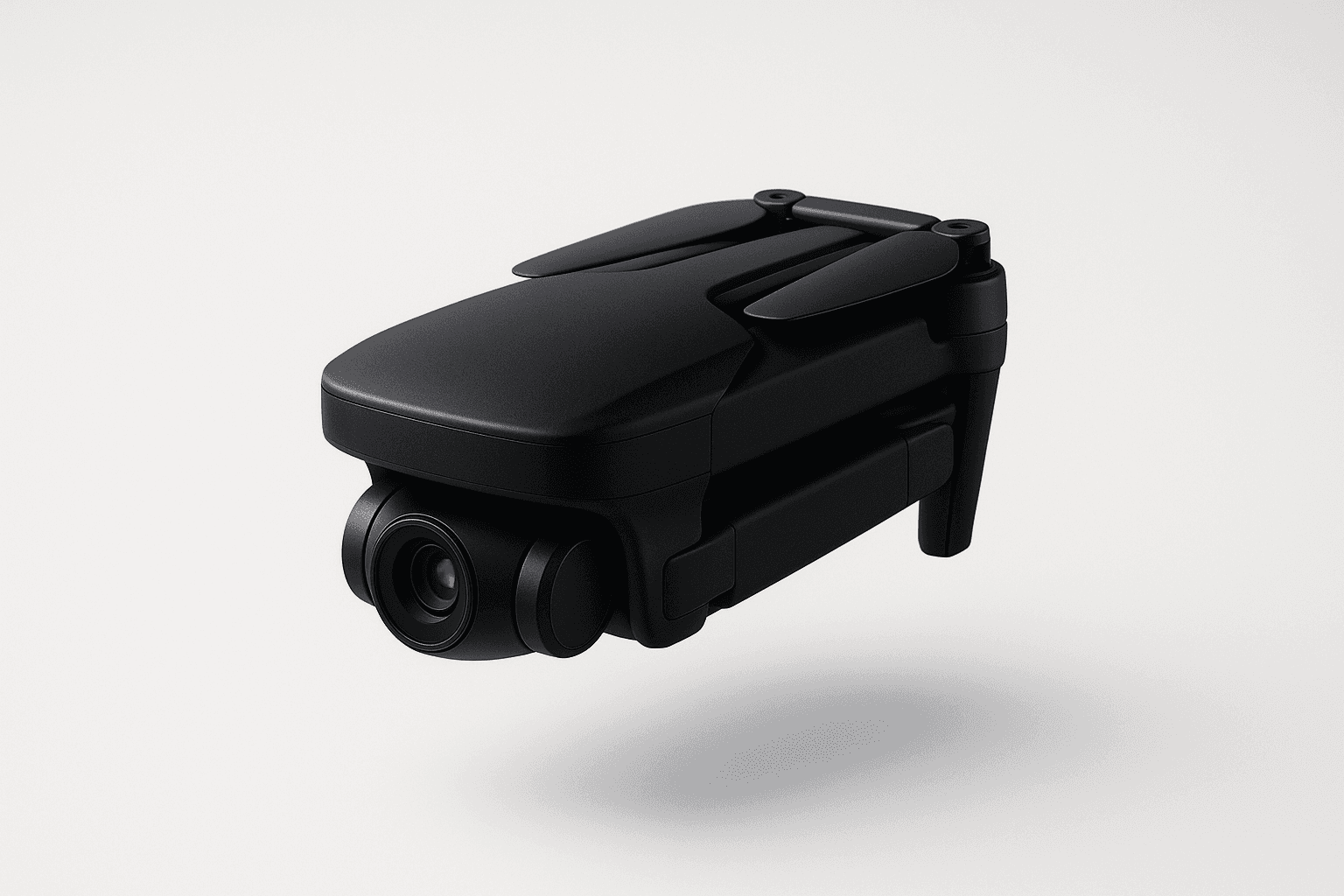 The image shows a sleek black drone with folded propellers and a camera lens at the front, isolated against a white background, highlighting its compact and portable design.