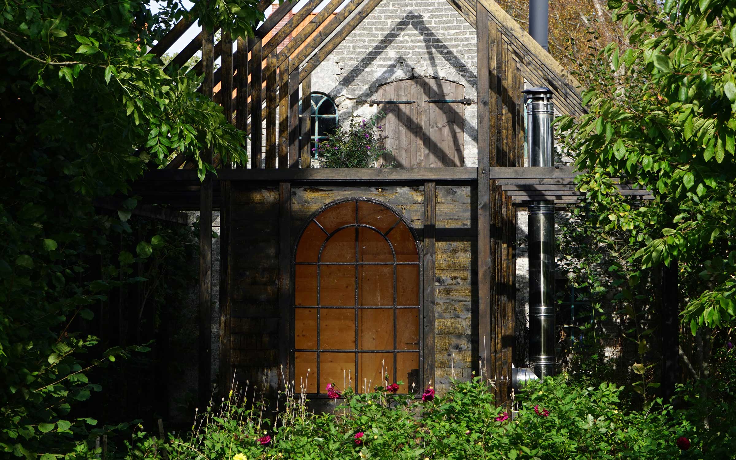 Bakkely Sauna and Guest House exterior with timber structure and garden setting on Ærø designed by Asger Risborg Jakobsen