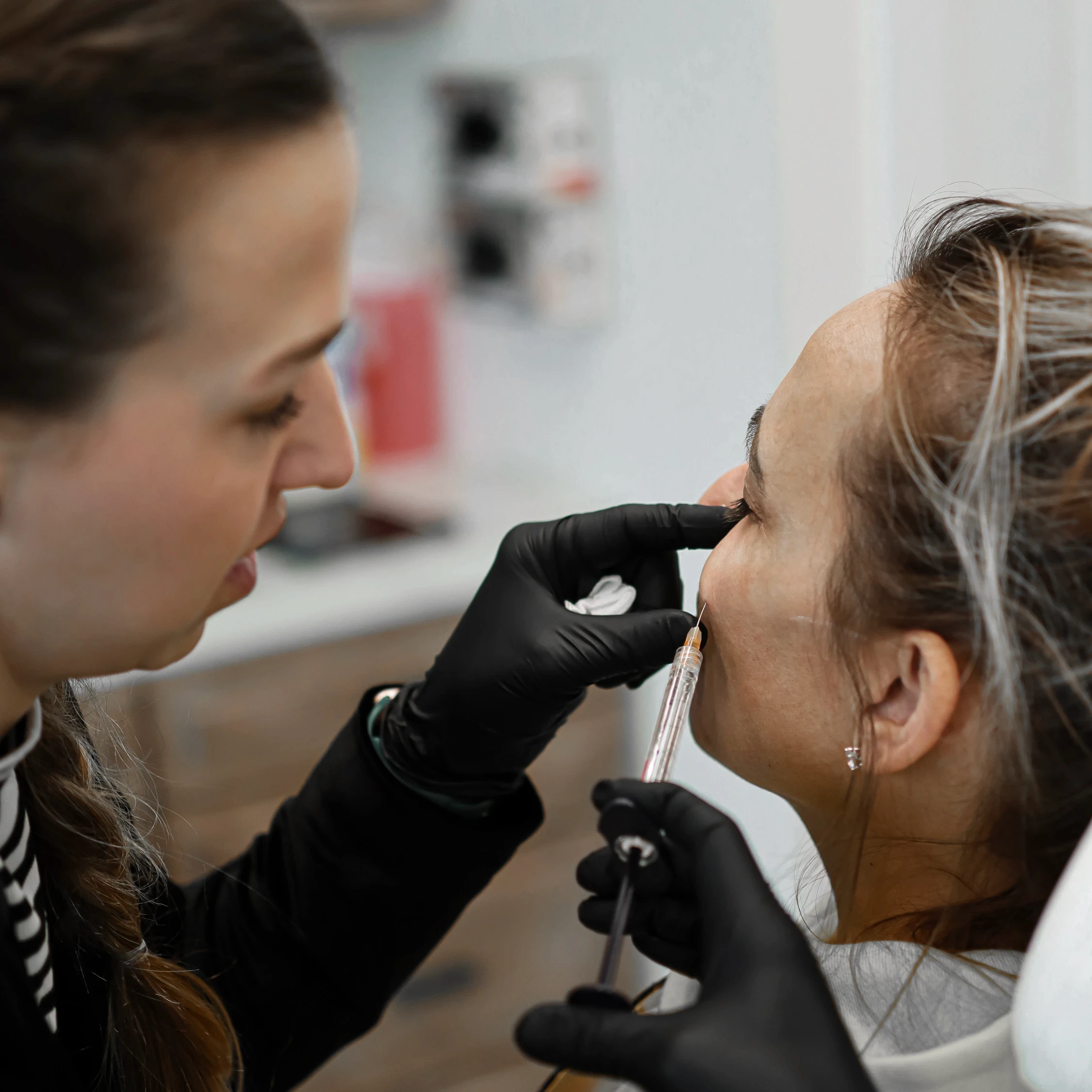 Chelsey Galipeau injecting a patient's cheek