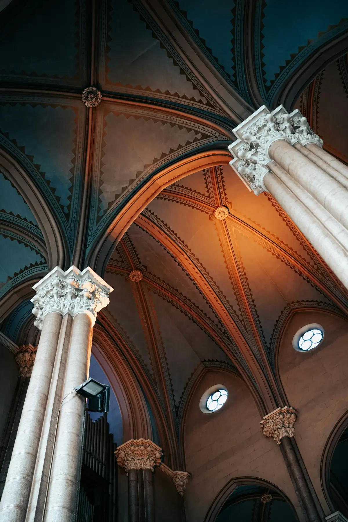 View of ornate architectural columns and ceilings, highlighting intricate patterns and lighting.