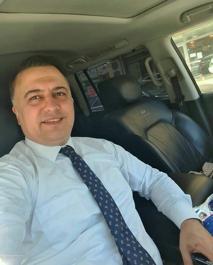 A person wearing the white shirt looking at the left