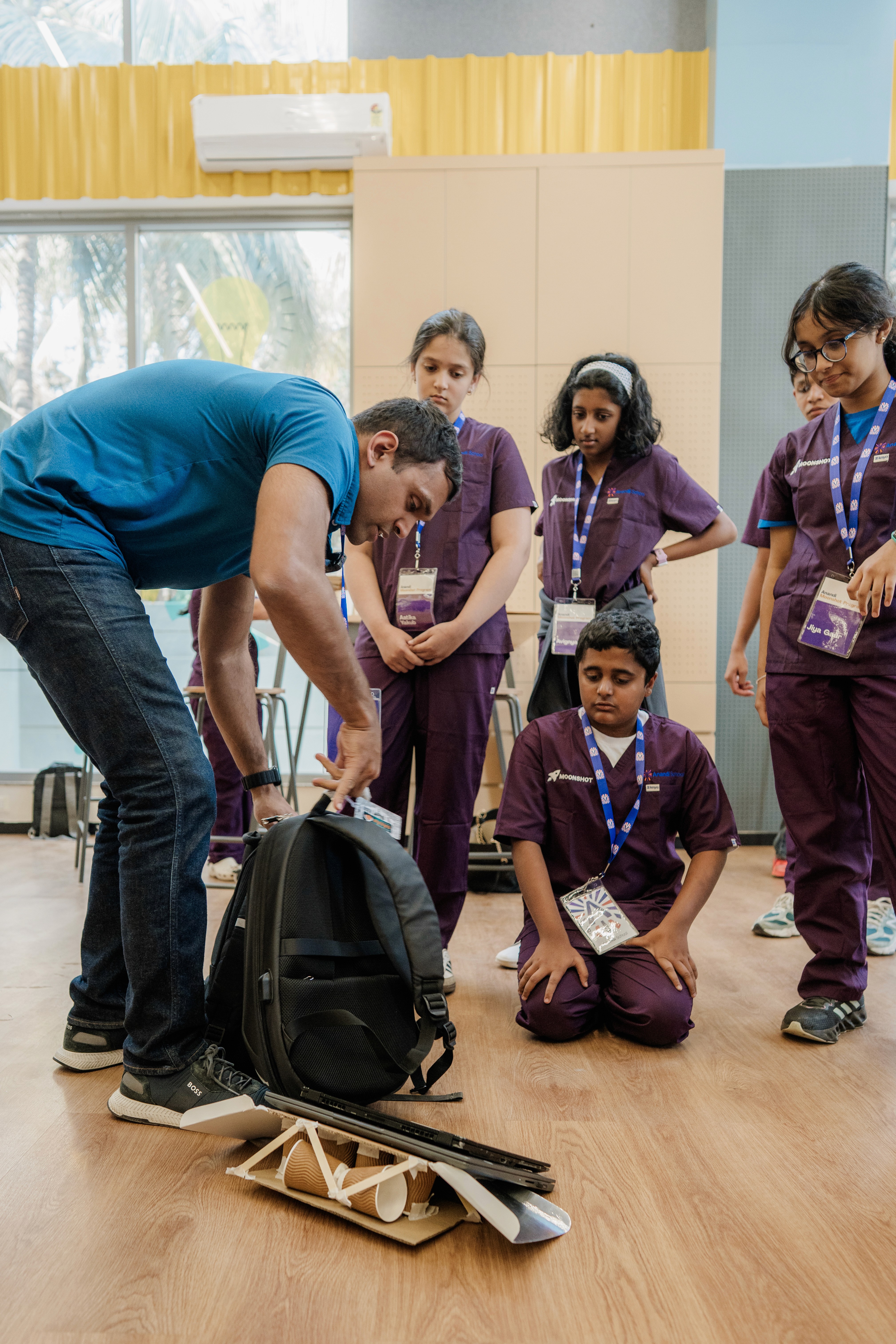 Demonstration of wooden bridge model promoting critical thinking.