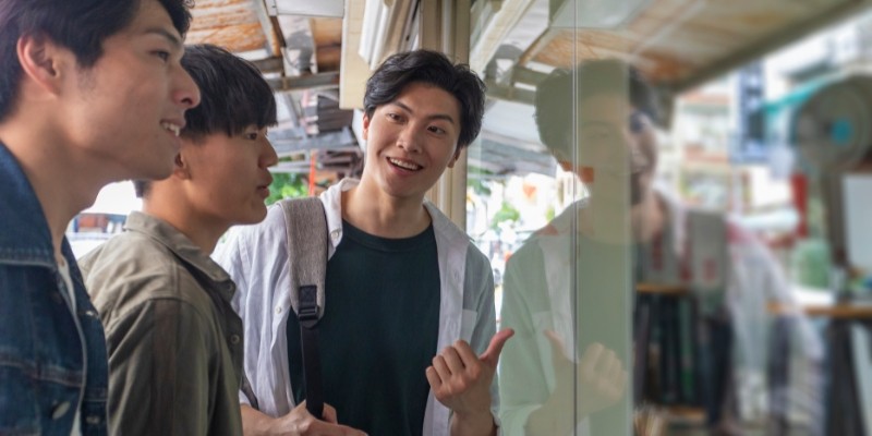 Asian friends window shopping at a retail store