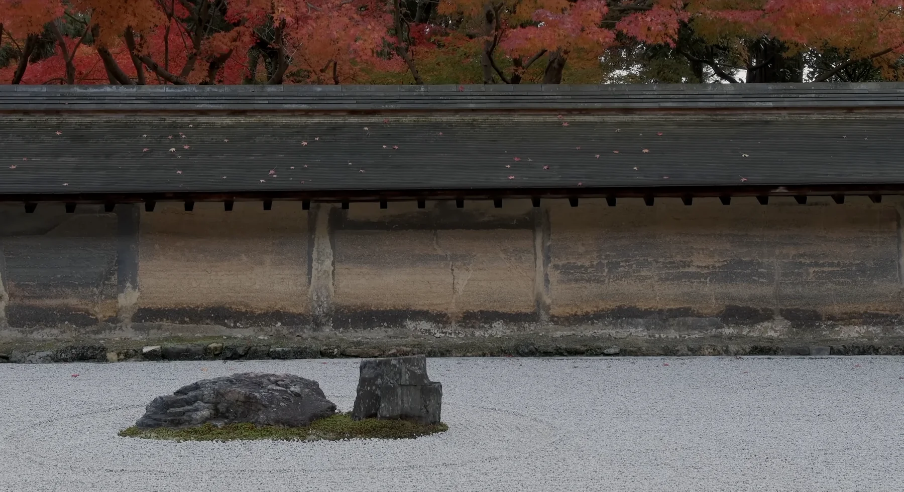 A dry rock garden below an earthen wall