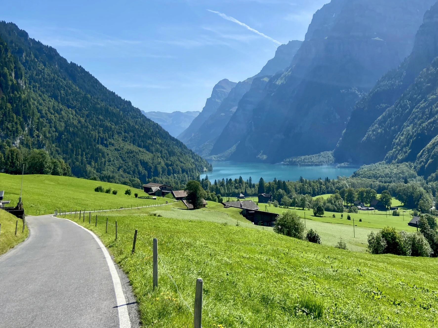 Quiet country road with mountain view of the Swiss Alps