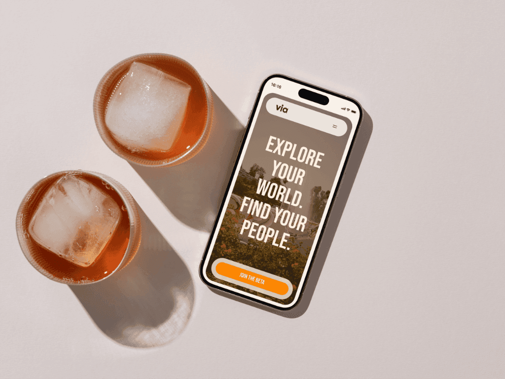 via website on a cell phone next to two cocktails