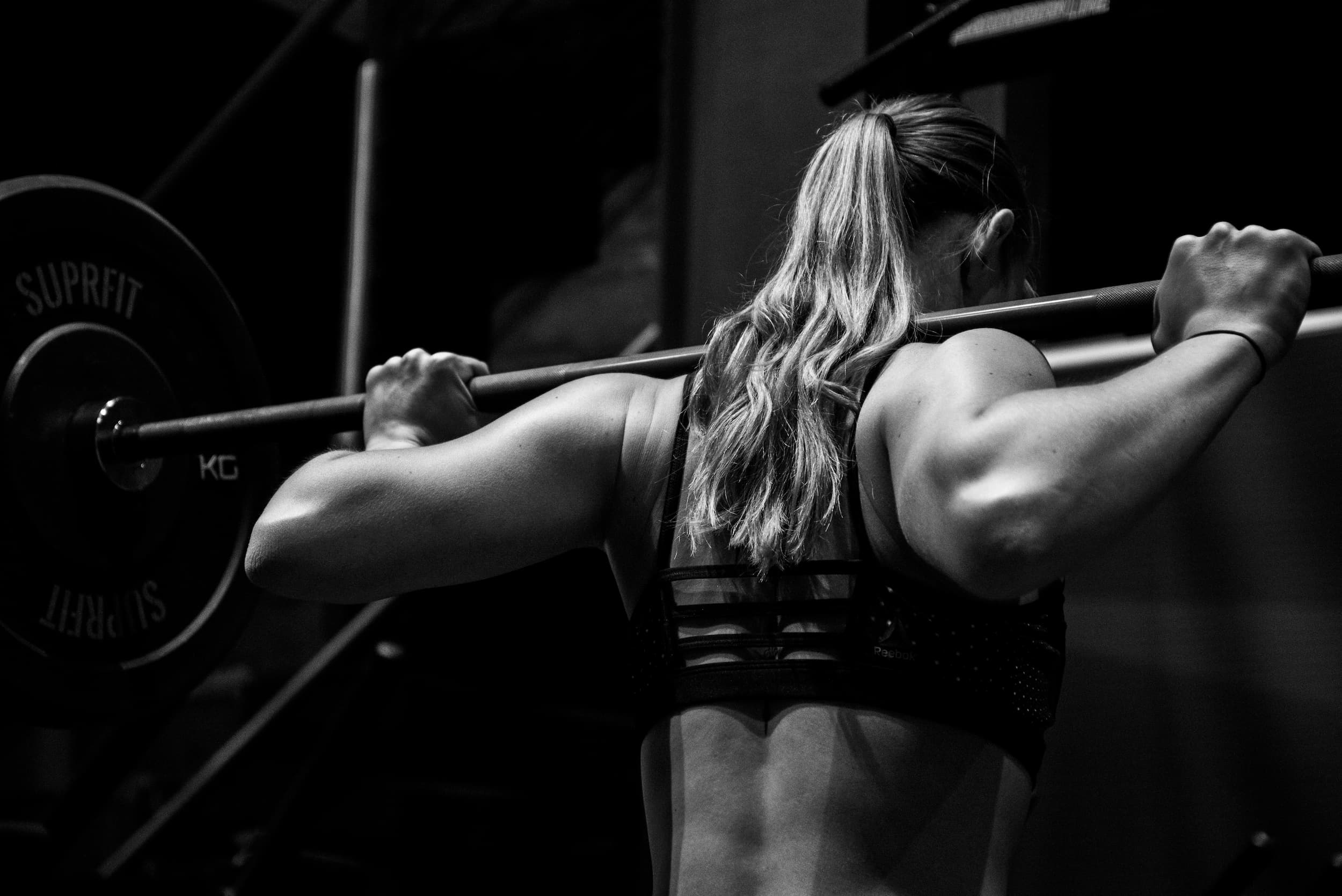 woman standing surrounded by exercise equipment
