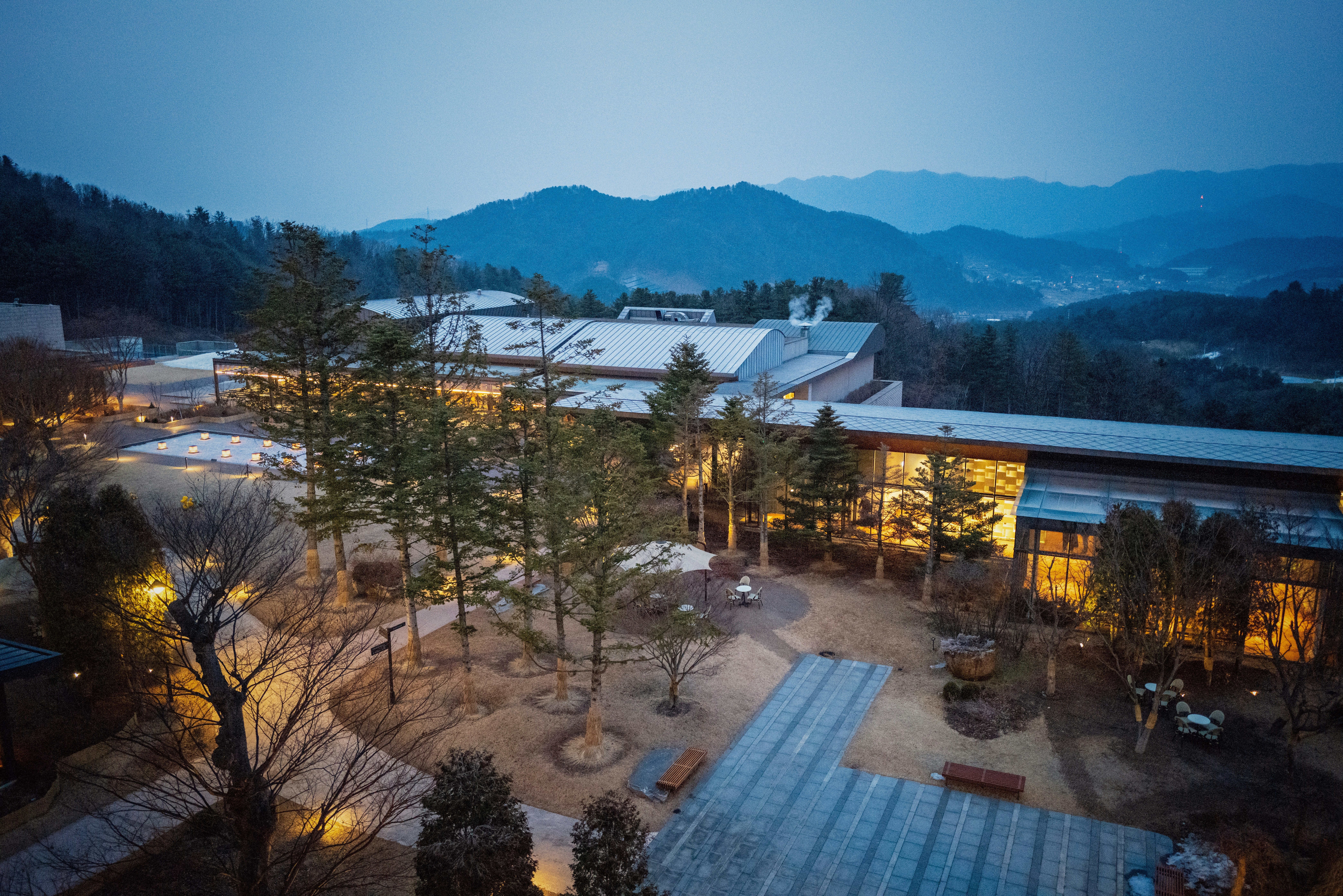 an aerial view of a building surrounded by trees