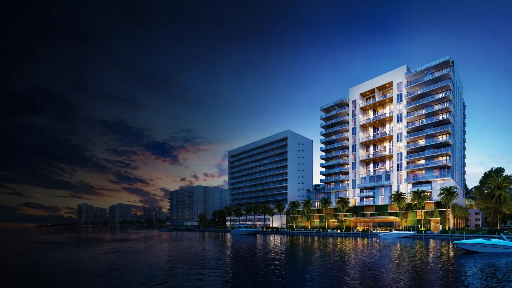Waterfront residential tower in North Bay Village illuminated at dusk, with balconies overlooking Biscayne Bay, palm-lined promenade, docked boats, and the Miami skyline at sunset.