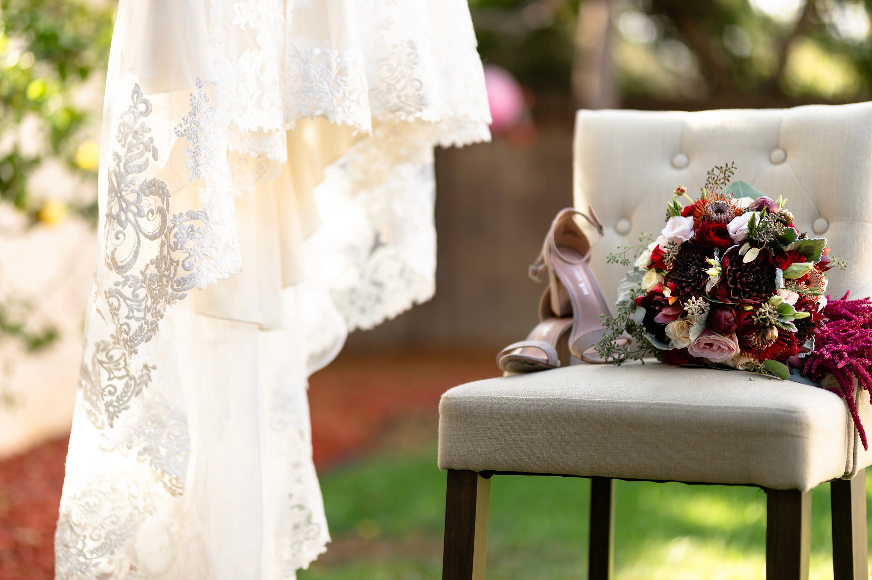 Flat lay wedding details with bouquet, rings, and sparkling bridal heels