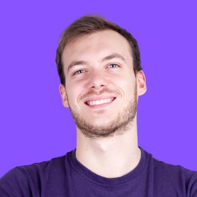 Smiling young man on purple background