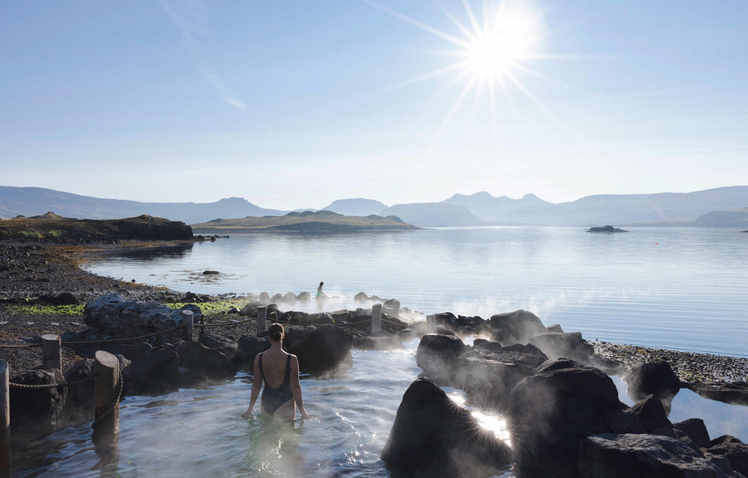 Hvammsvík Hot Springs with natural geothermal pools by the ocean and mountain views in Iceland