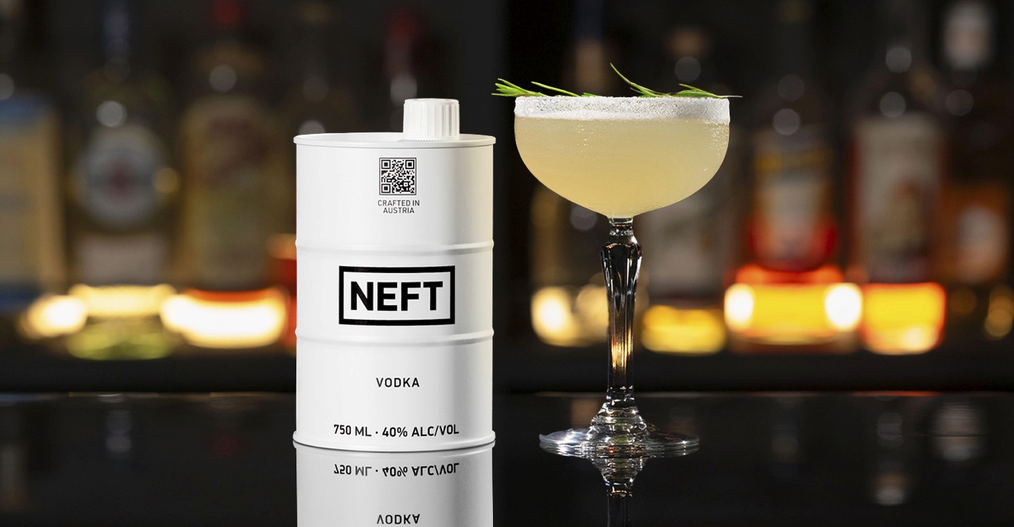 A NEFT Barrel and a glass of Nellie Bly on a bar counter.