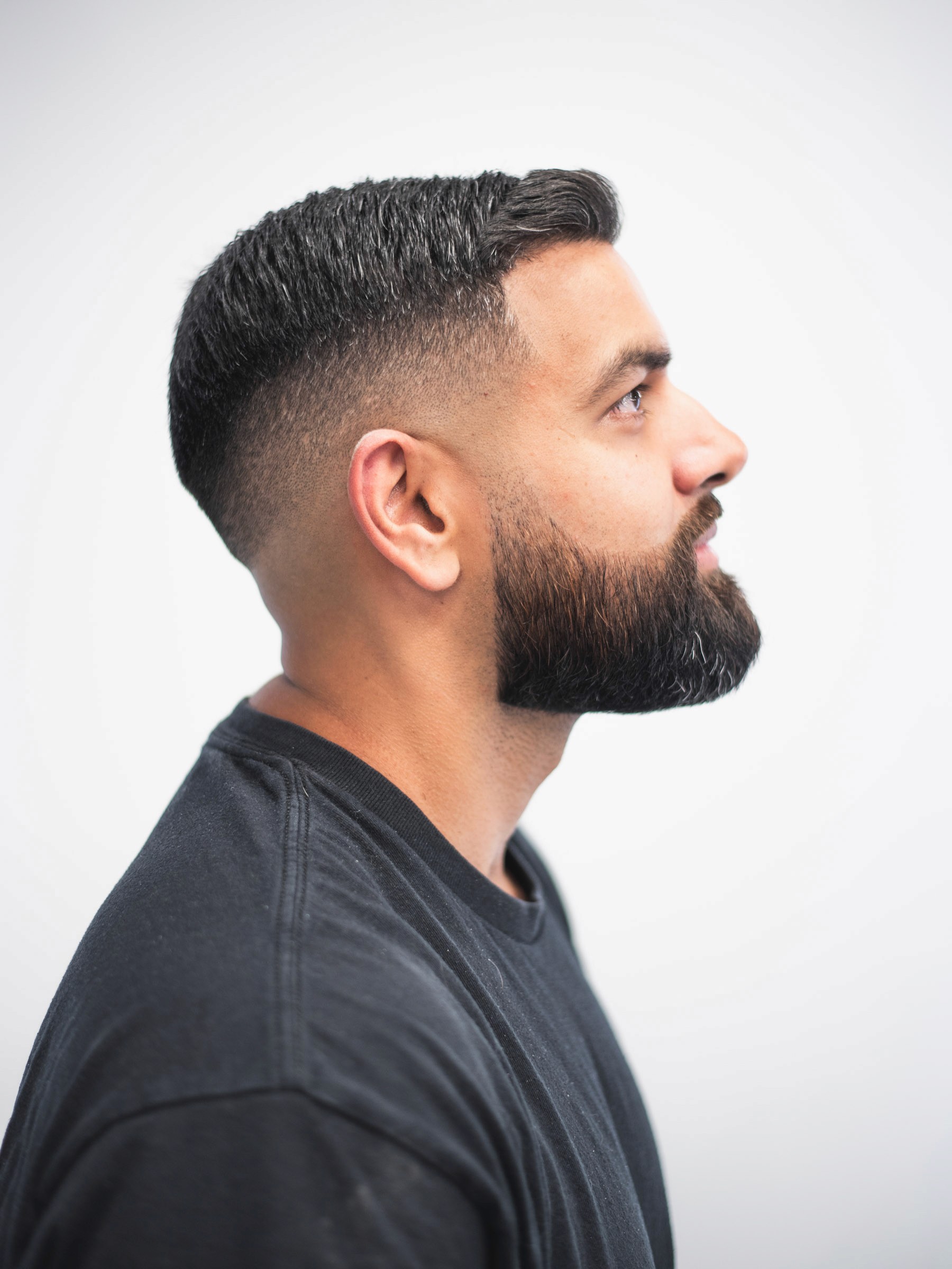 Green card with a white logo placed on top of a pile of white golf balls.