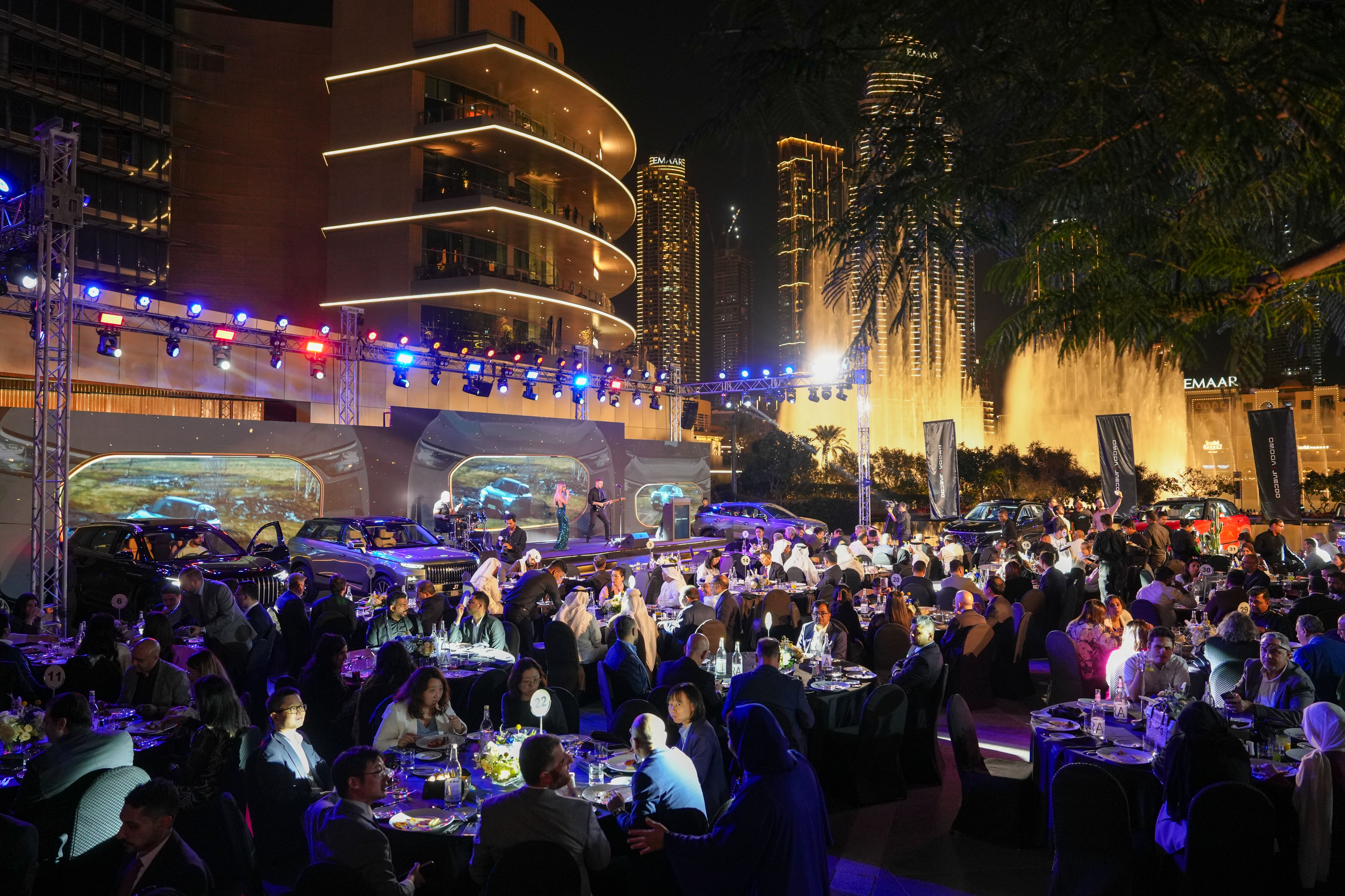 Female scientist wearing a white coat and gloves examines a sample slide in a modern laboratory setting.