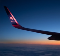 Airplane wing against a colorful sunset