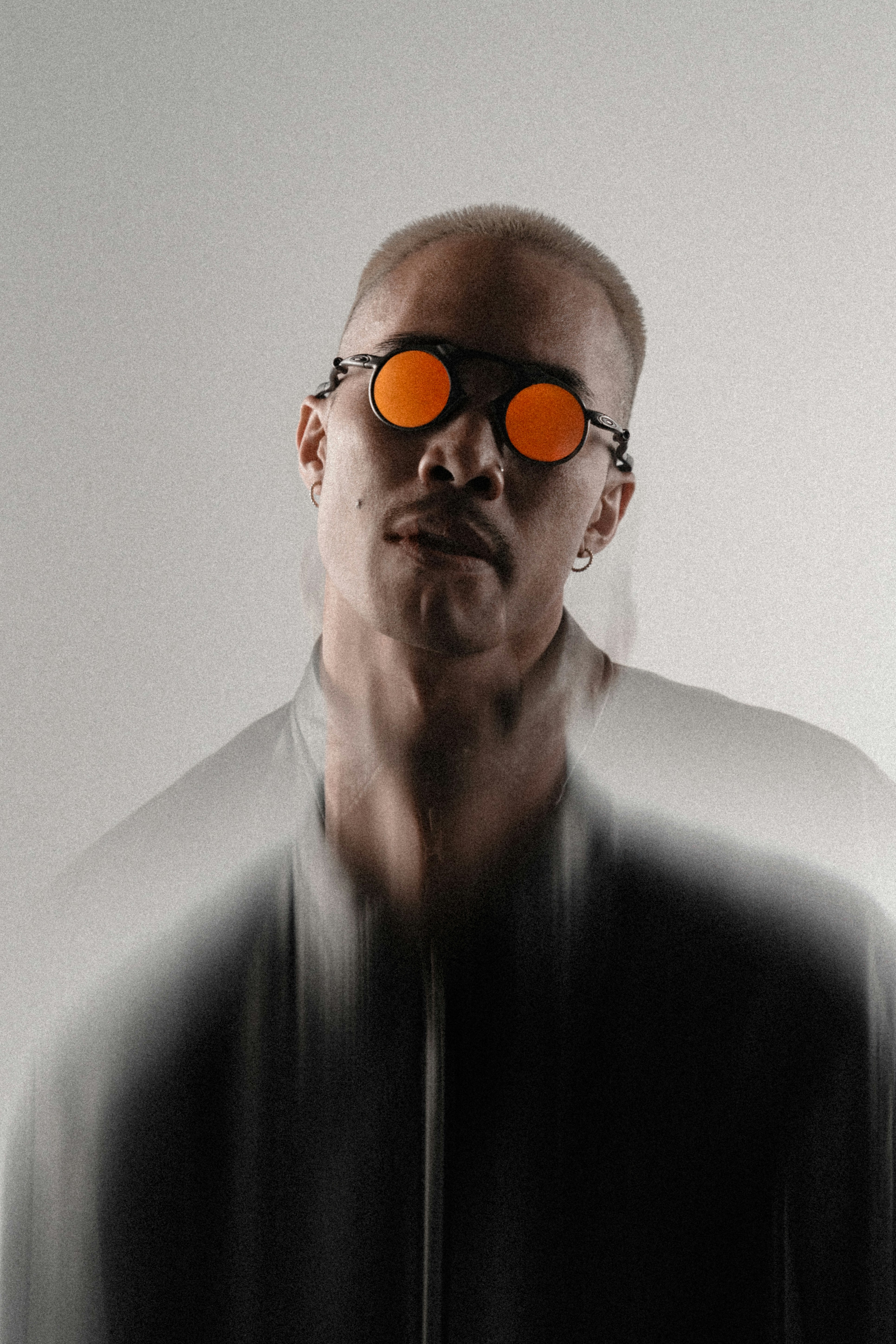 Man with orange sunglasses and blurred effect