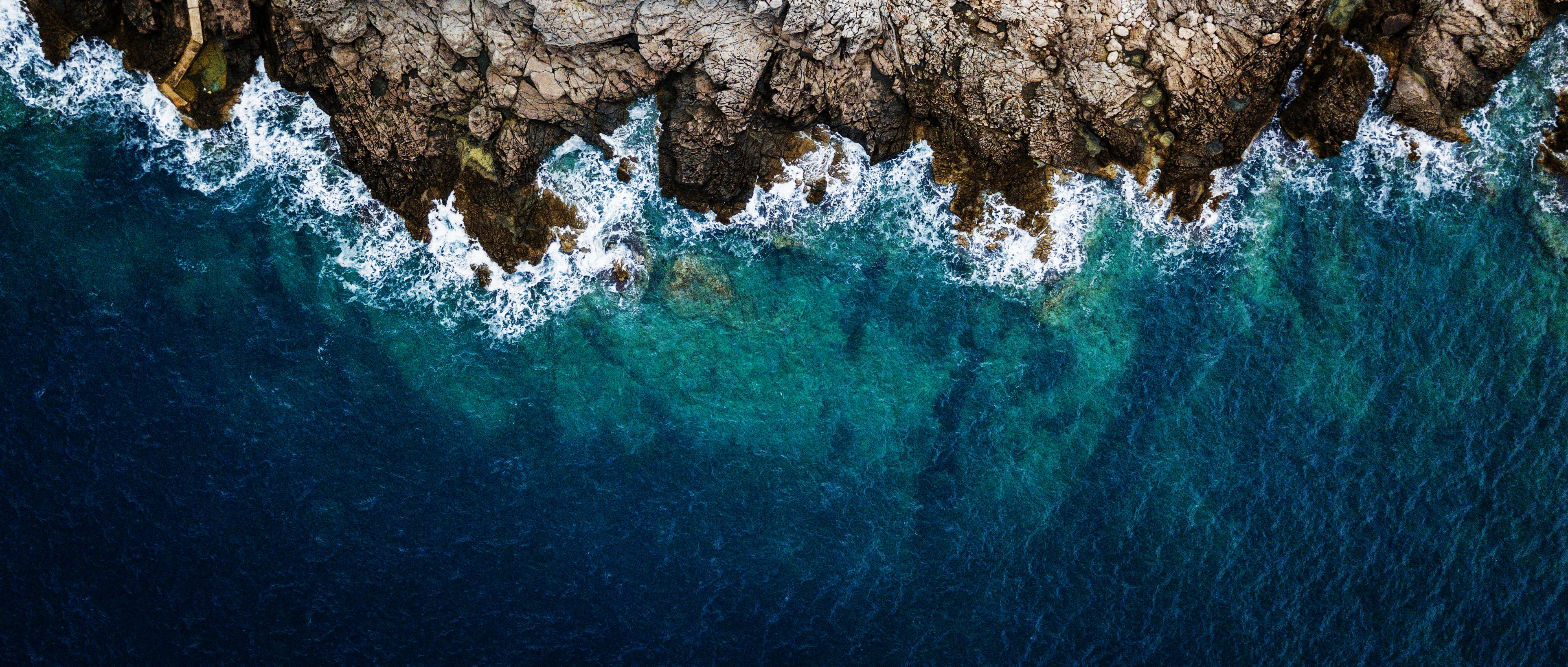 Cliff, blue clear ocean, waves, foam, cliff broke they waves