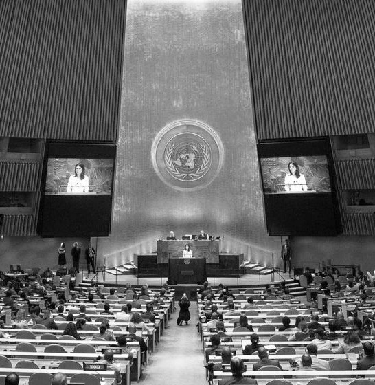 Speaker addressing an audience inside the United Nations General Assembly hall.