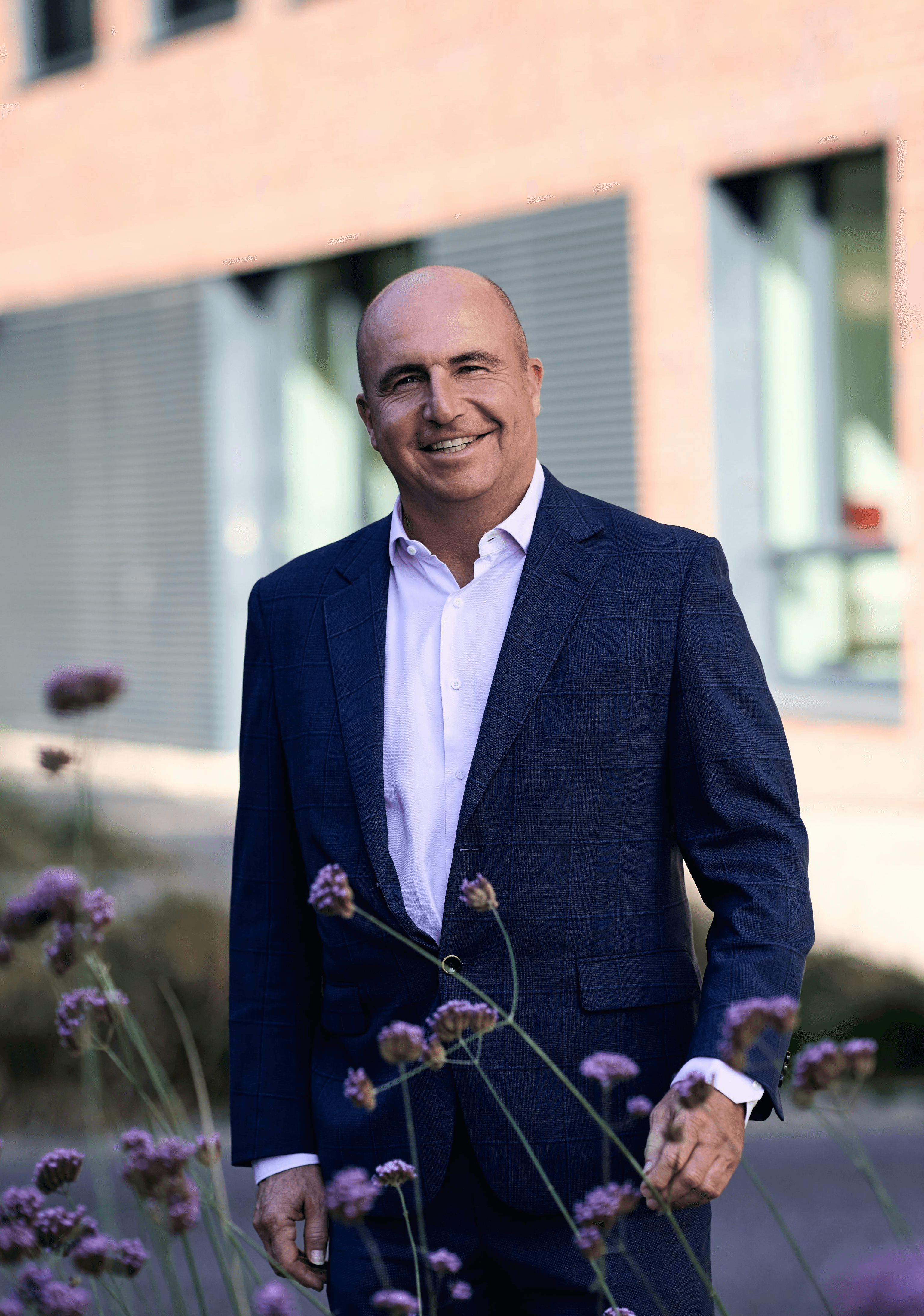 Senior man in a blazer, standing outdoors