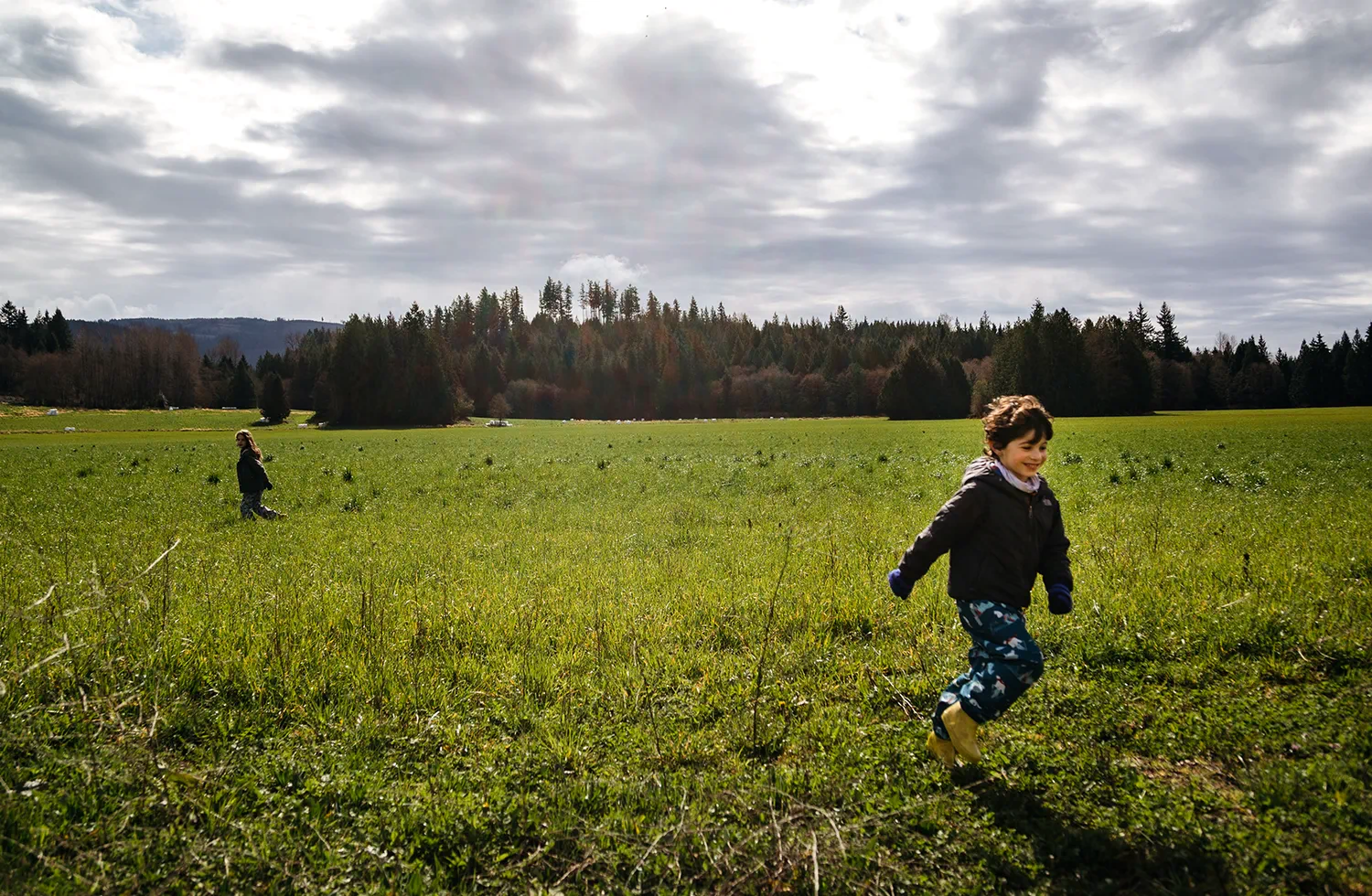Children running through open land and meadows.
